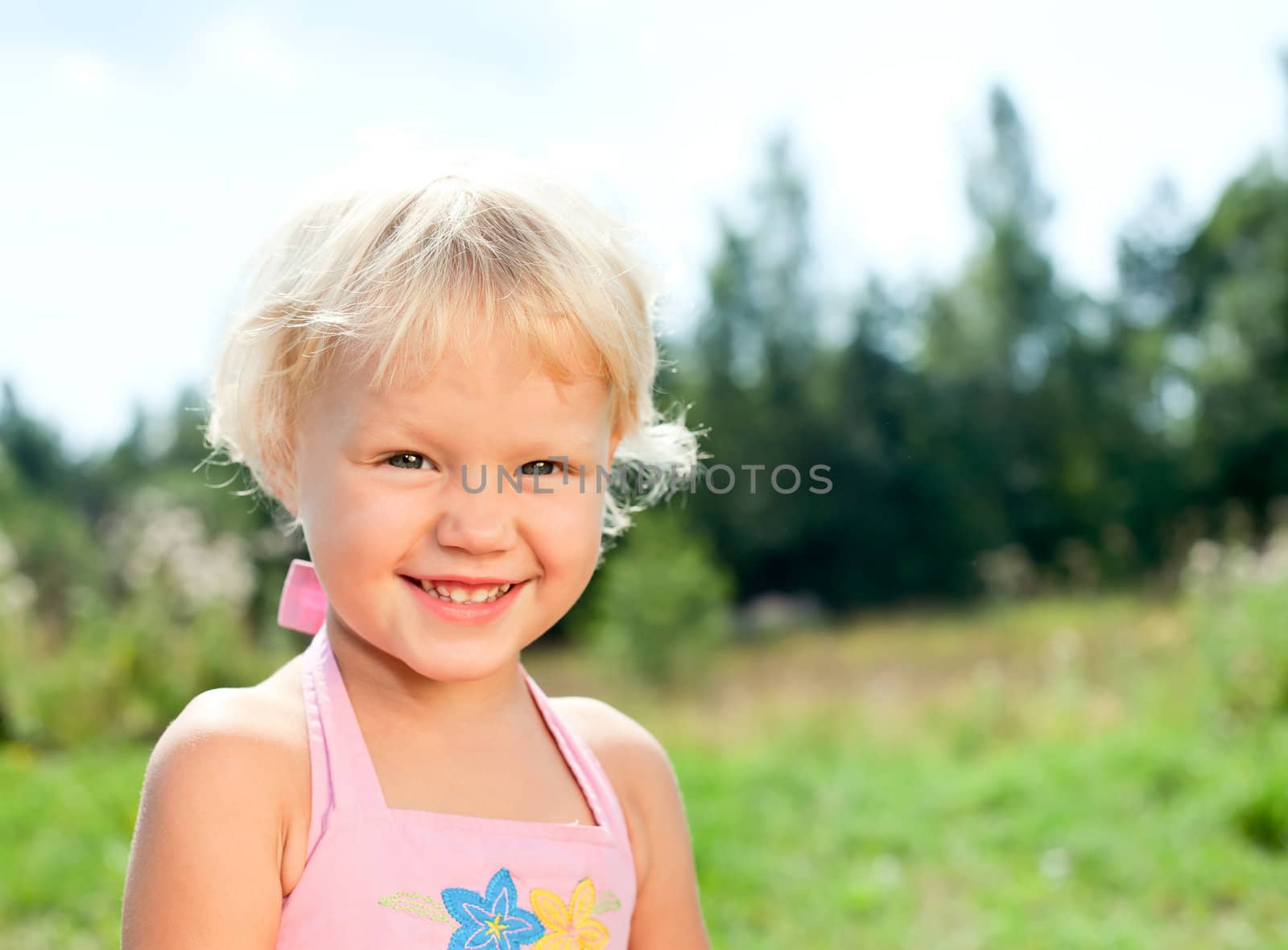 Portrait of cute little girl enjoying a summer day outdoors