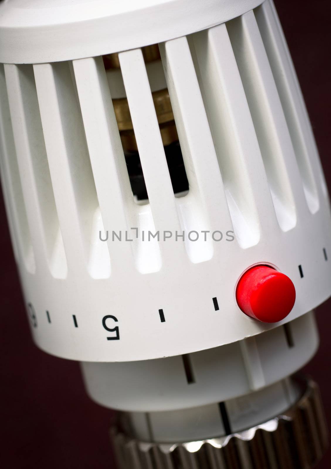 Thermostatic radiator valve with red economy button close-up