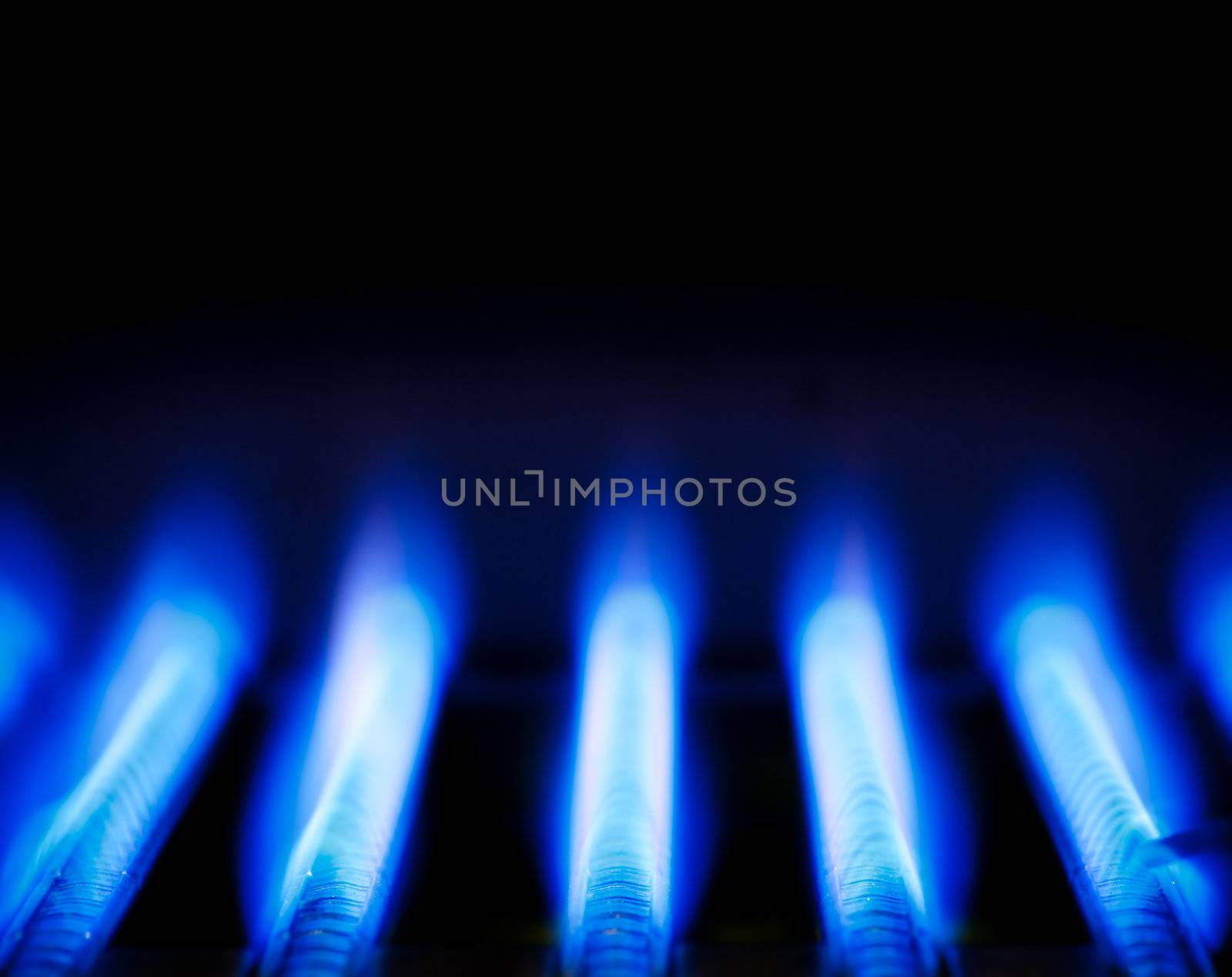 Blue flames of a gas burner inside of a boiler