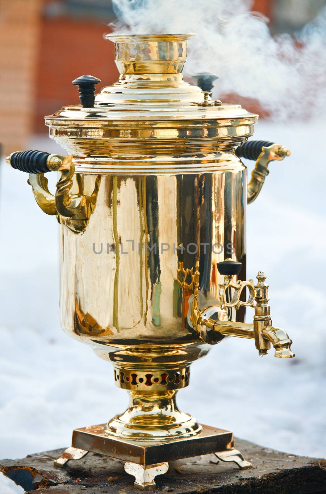 Vintage smoking golden Samovar, the traditional russian water boiler