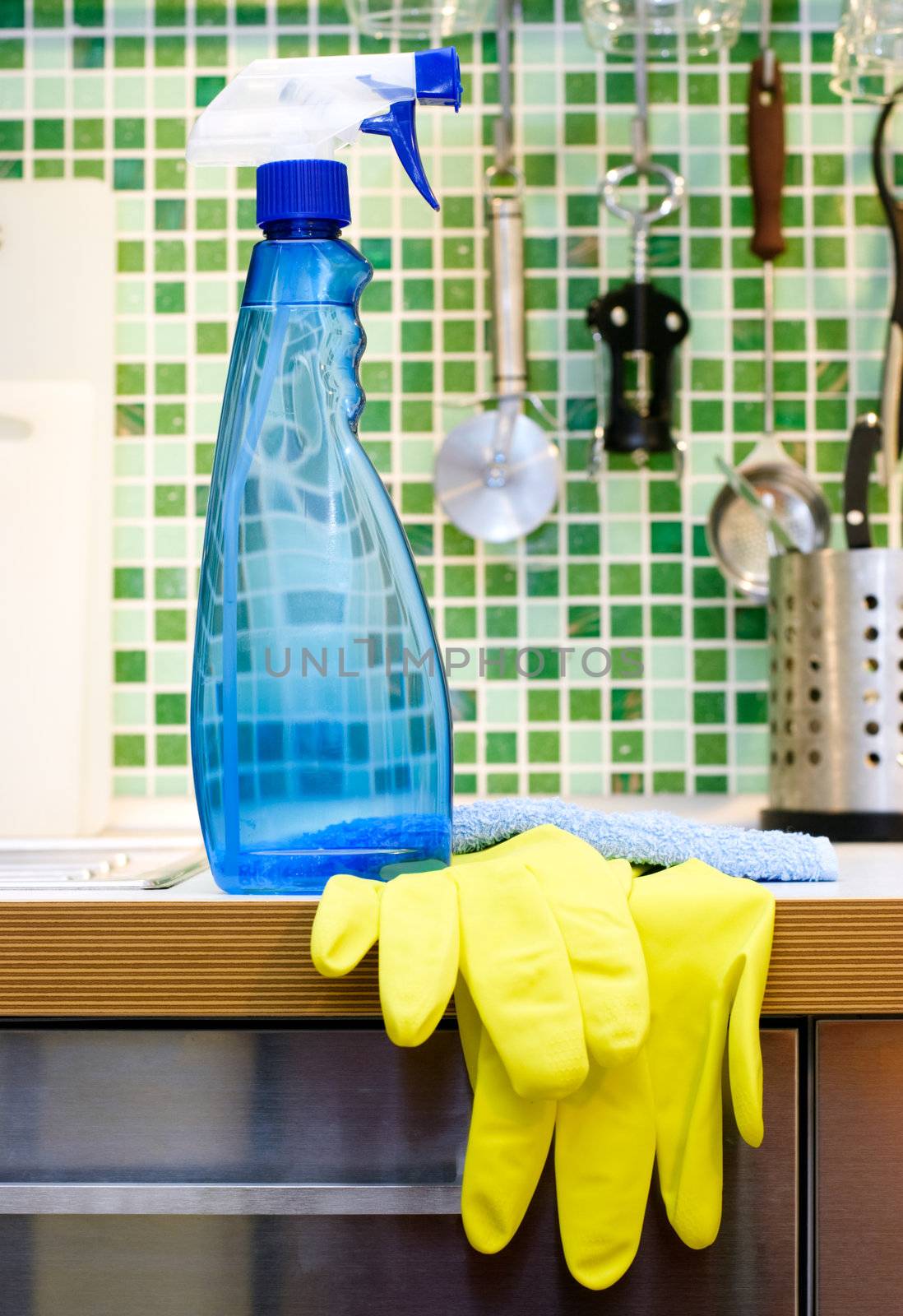 Blue cleaning spray bottle on kitchen table