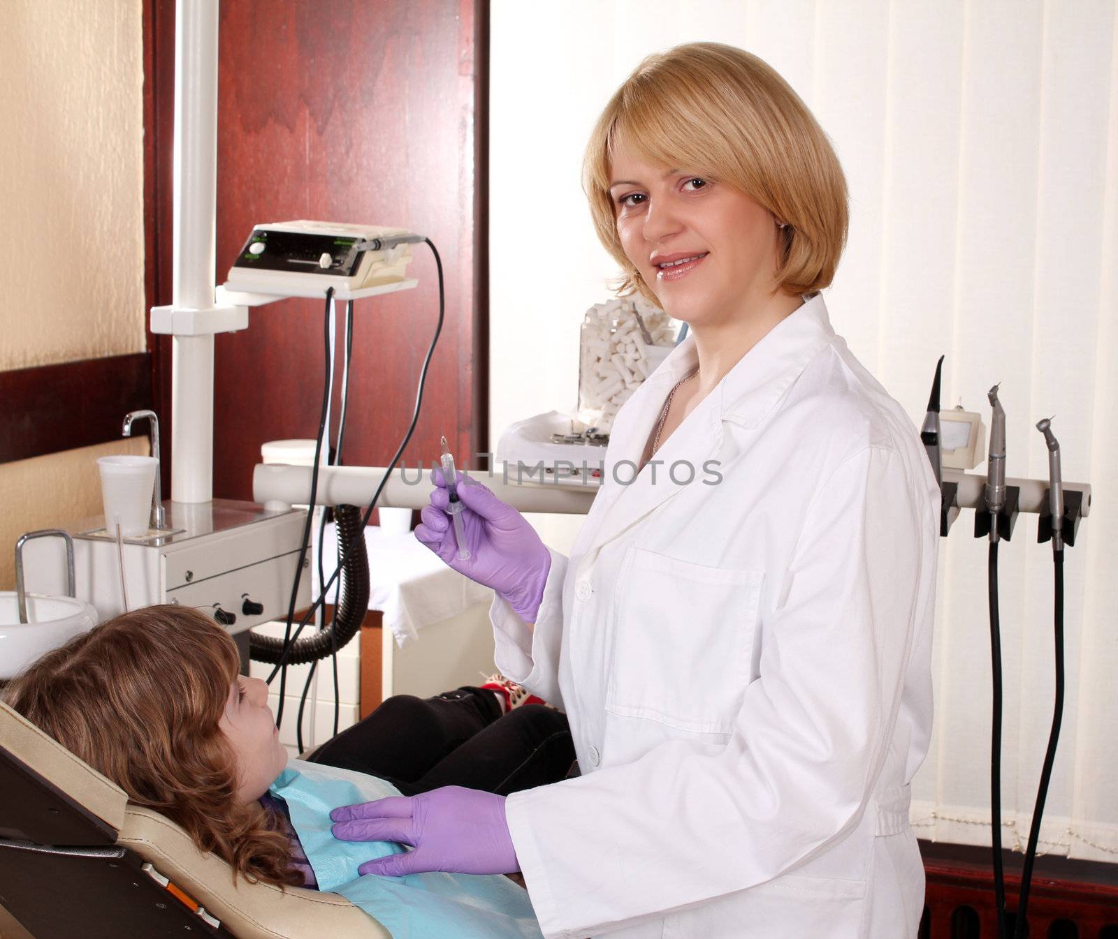 female dentist and child patient by goce