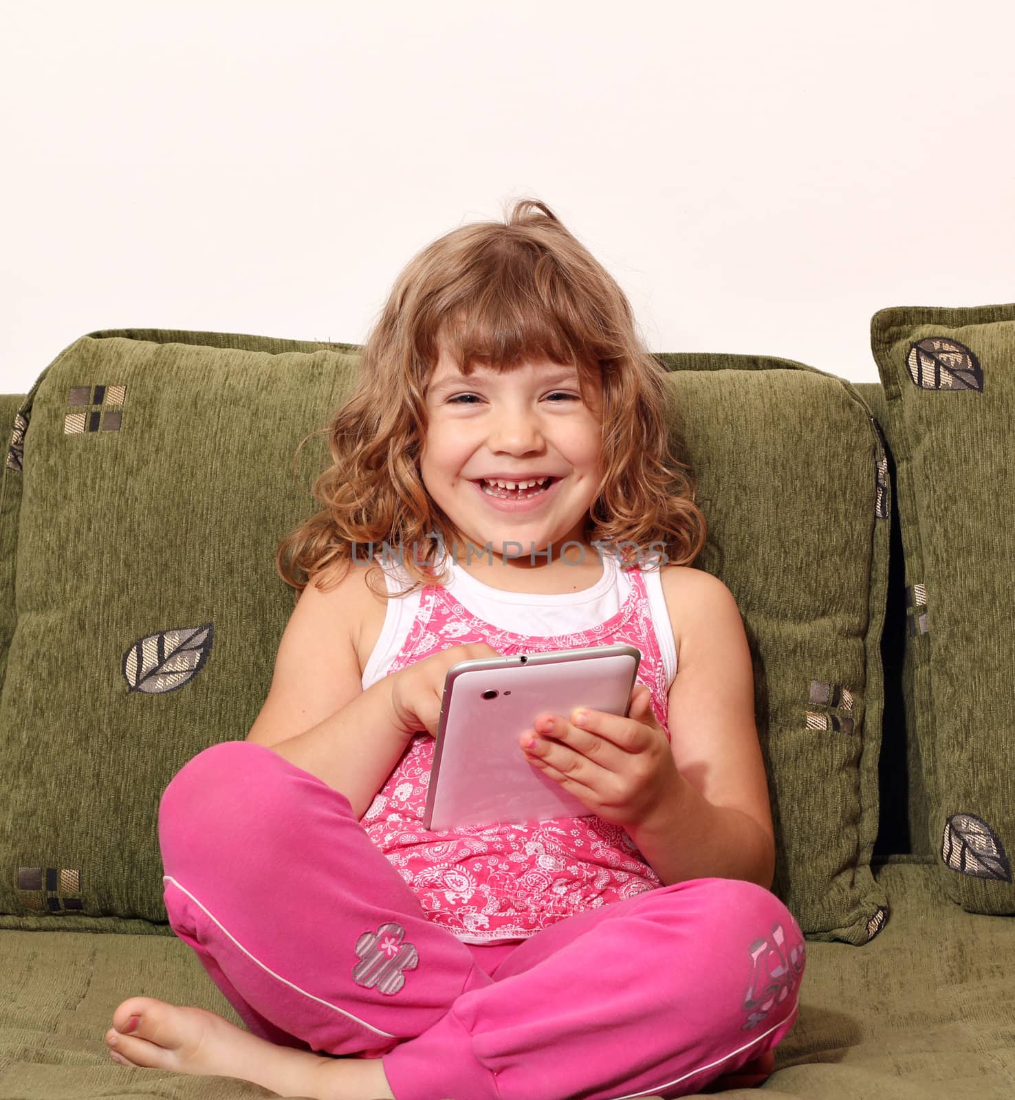 happy little girl fun with tablet pc by goce