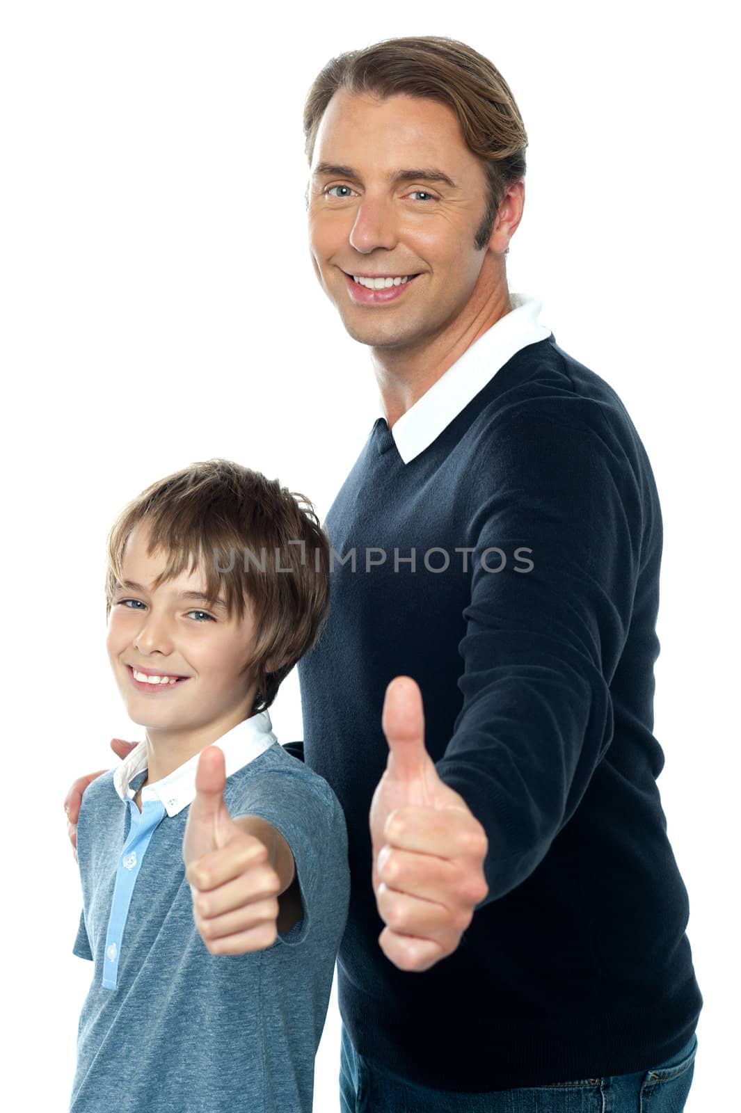 Confident father and son duo  gesturing thumbs up sign. Smiling faces