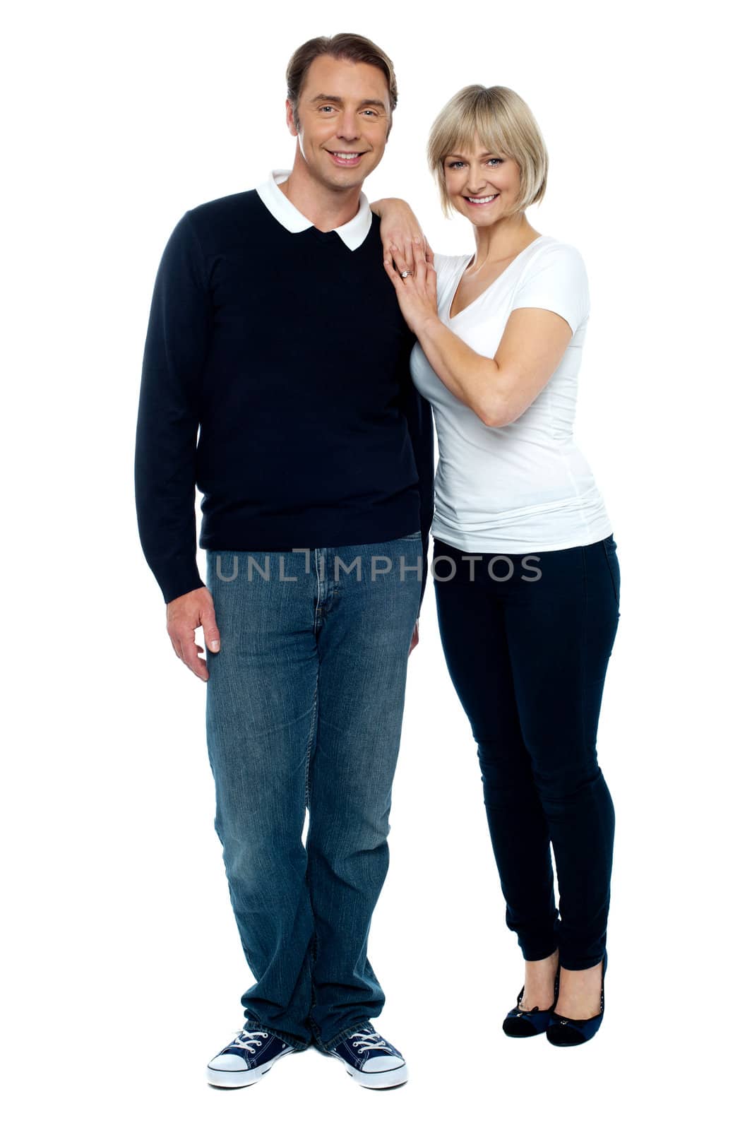 Casual portrait of trendy middle aged love couple. Full length portrait.