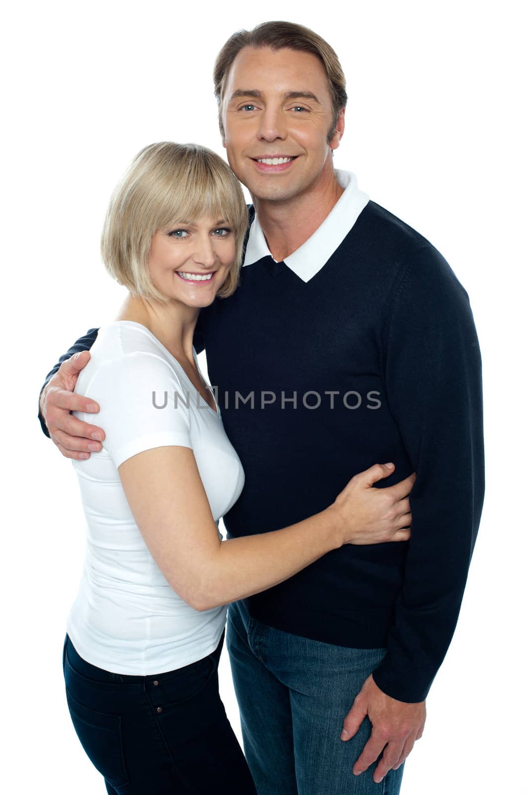 Stylish man in pullover embracing his blonde wife by stockyimages