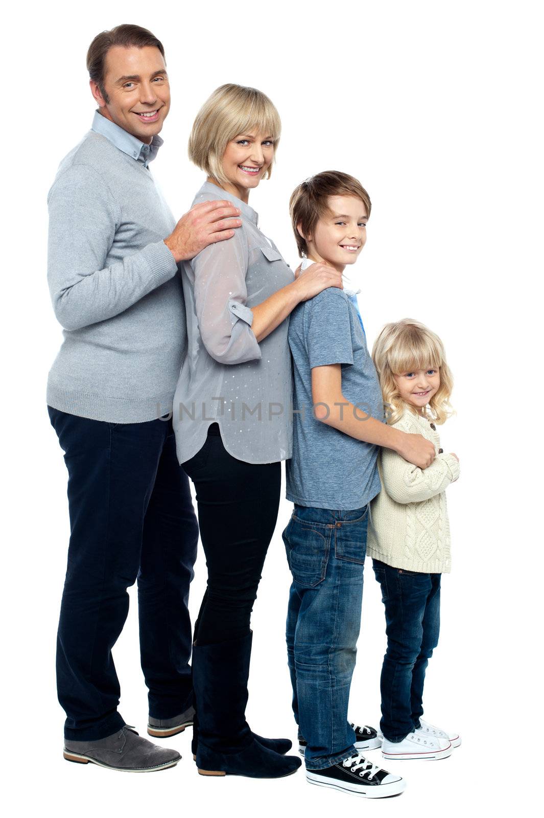 Full length family portrait of four members. Standing in a line formation.