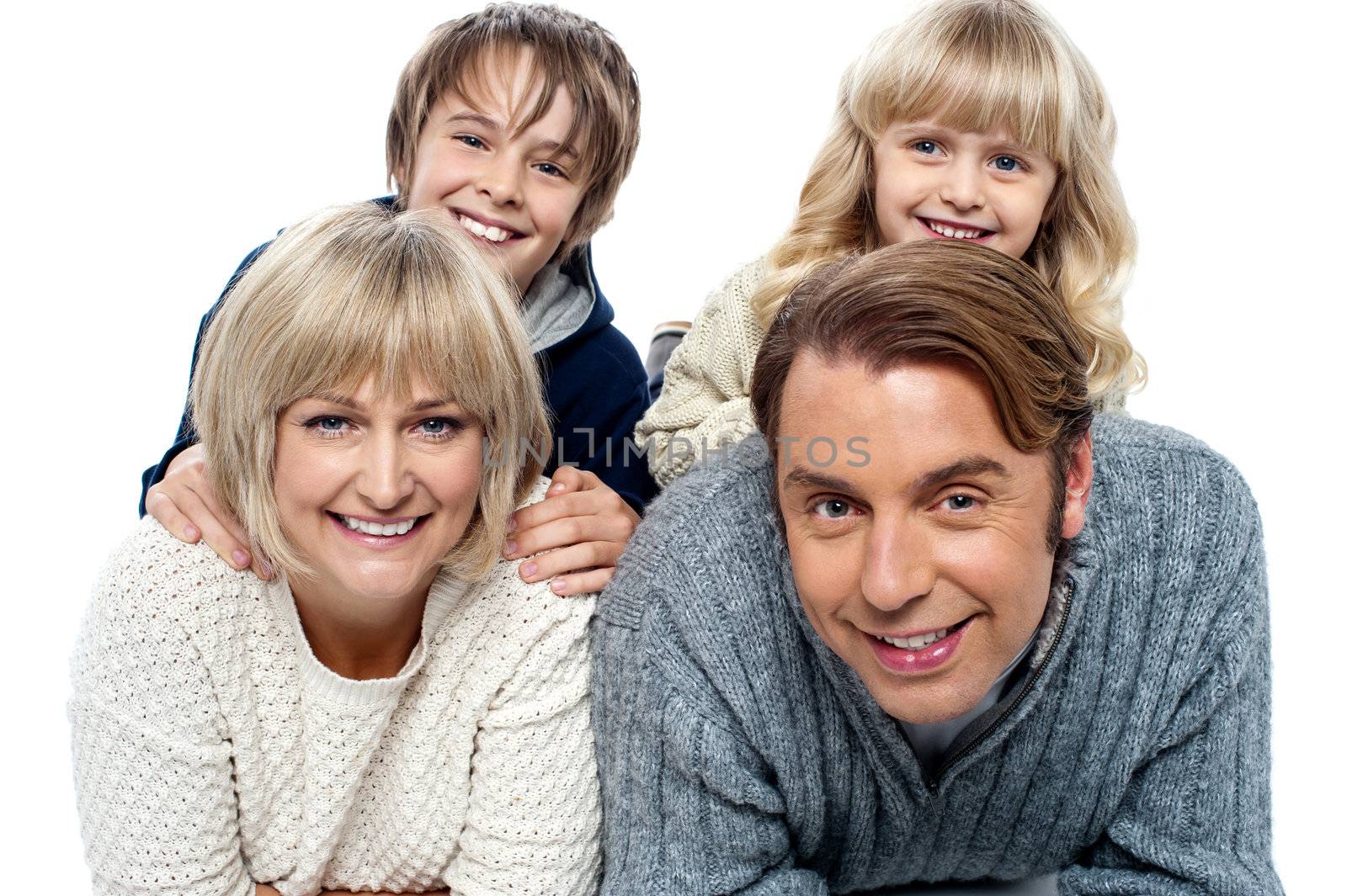 Spirited kids having fun with their parents indoors by stockyimages