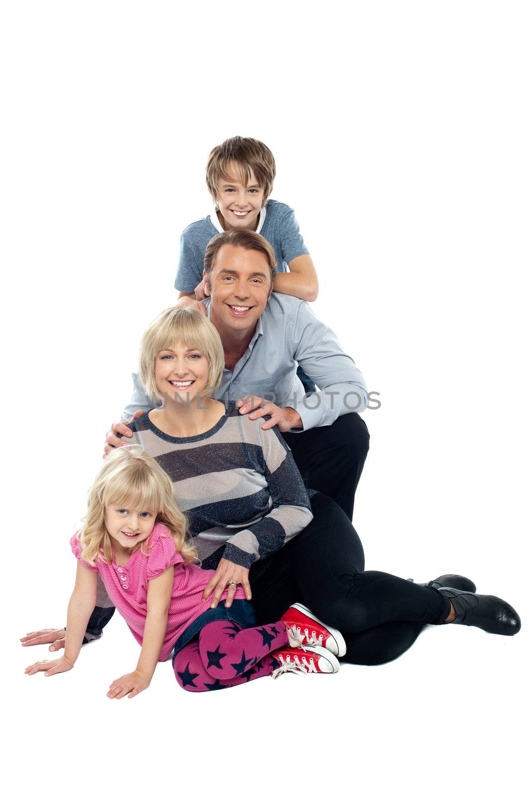 Closely bonded family in a studio. Isolated against white background.