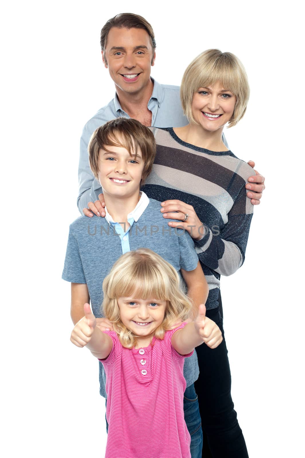 Group portrait of a playful family of four. Smiling heartily