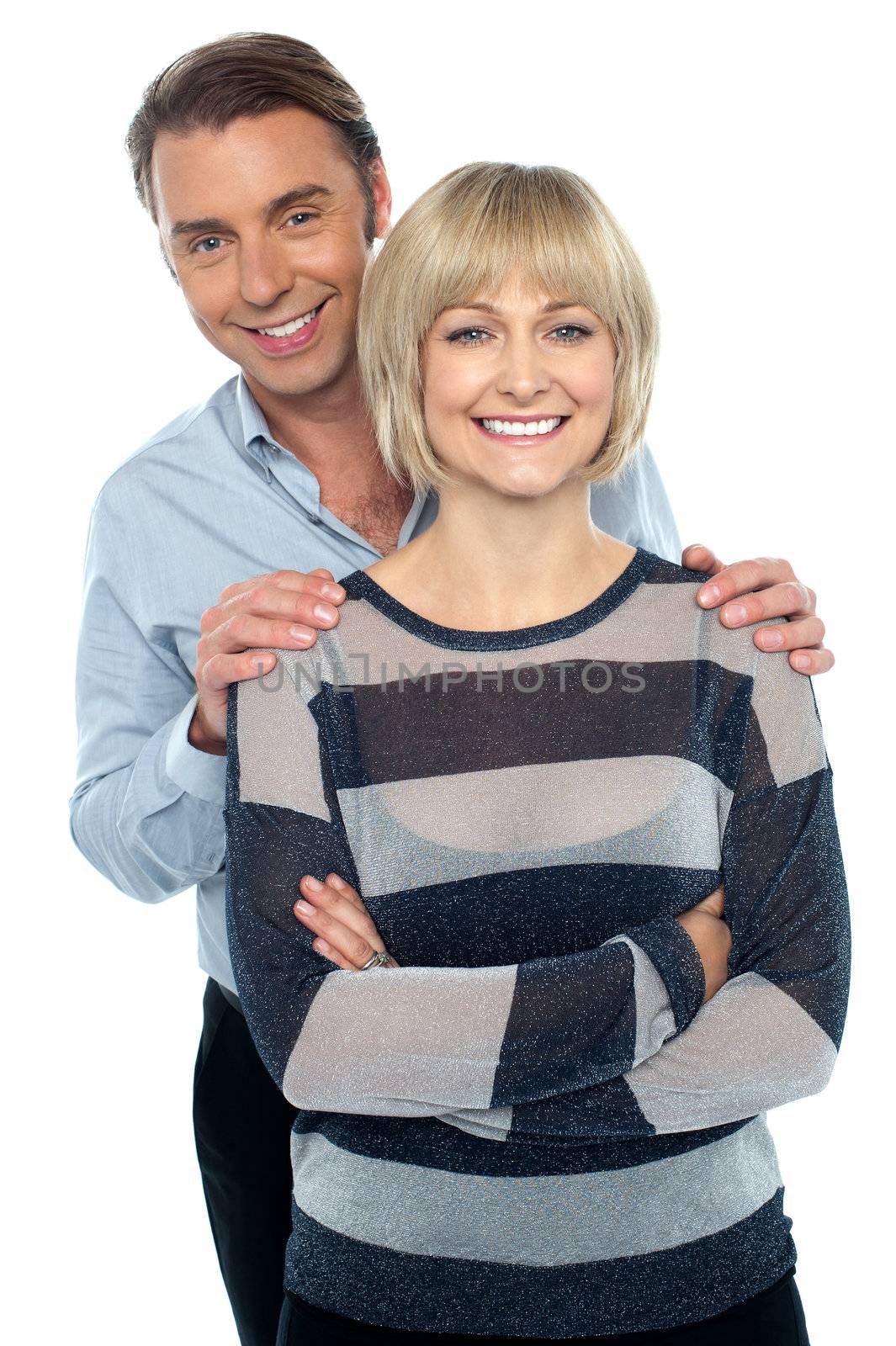 Lovely young couple portrait against white background by stockyimages