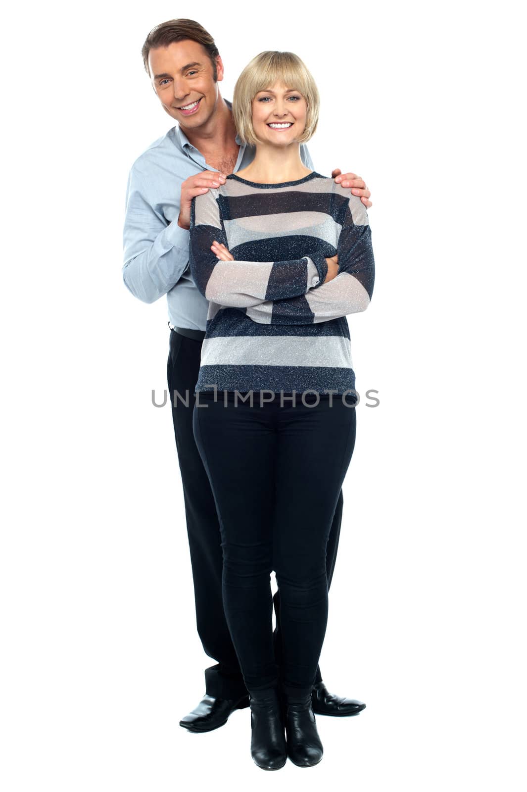 Middle aged husband holding his wife from behind by stockyimages