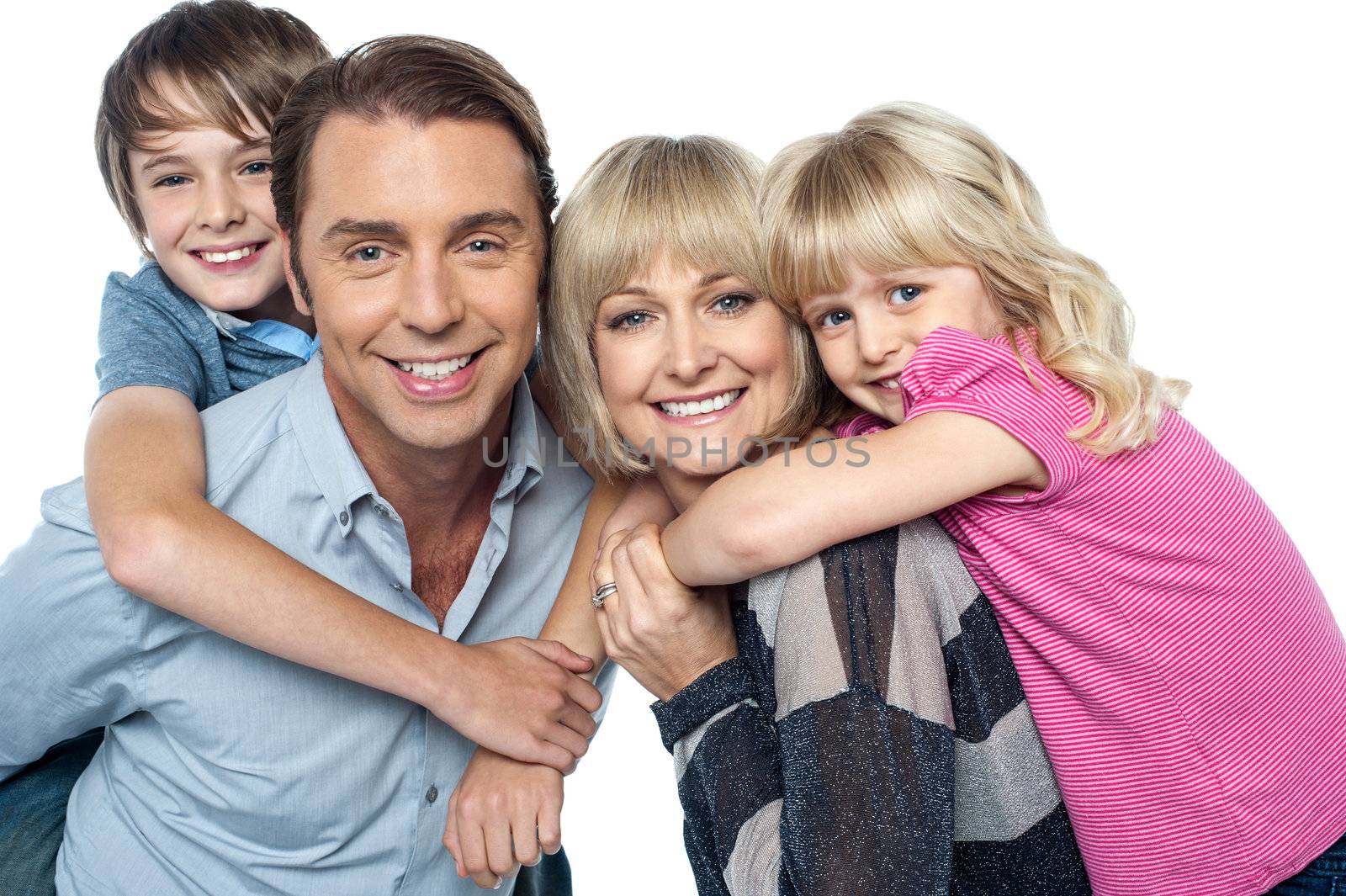 Happy family of four members posing together by stockyimages