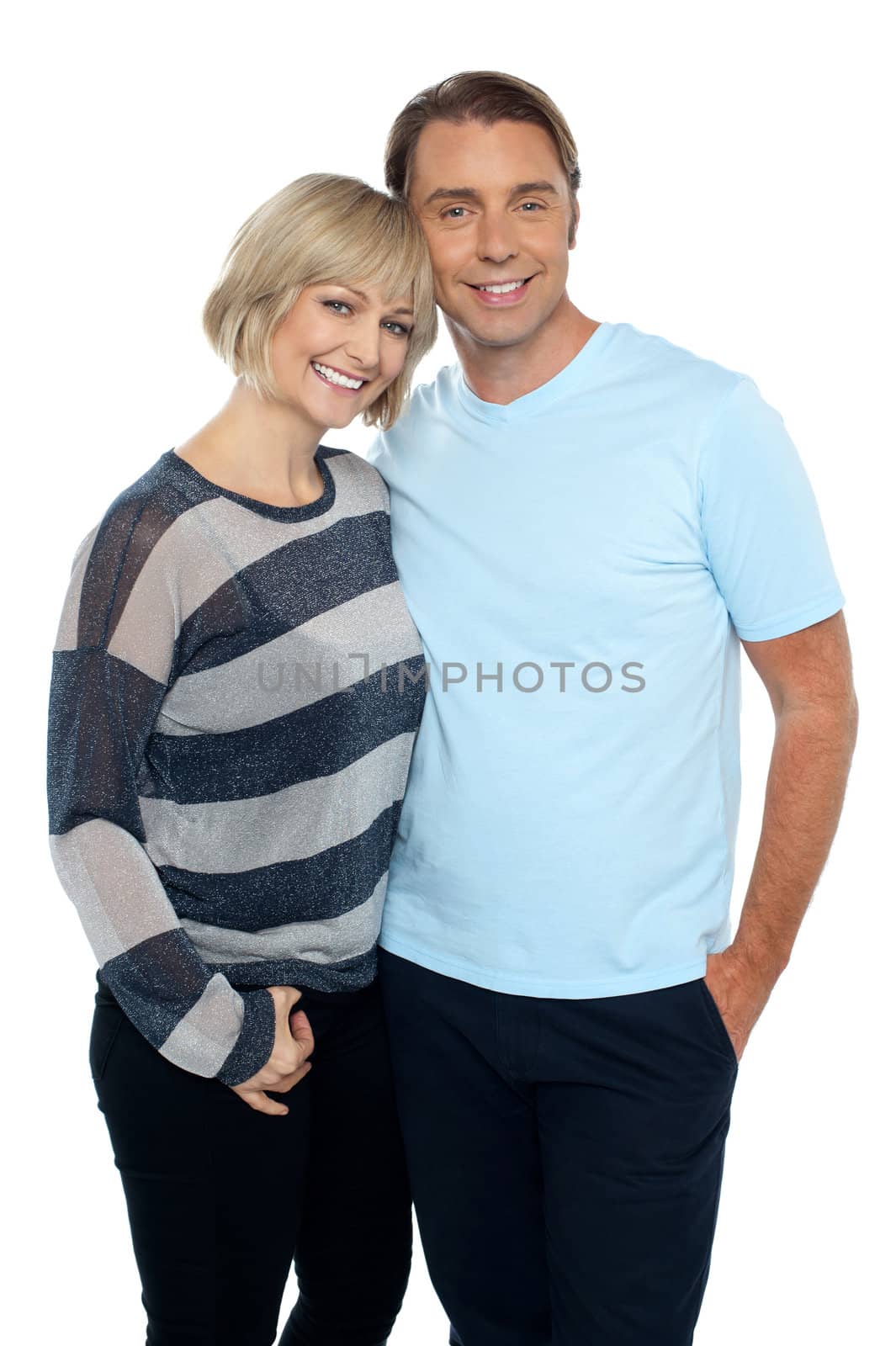 Portrait of a romantic young couple standing together over white background.
