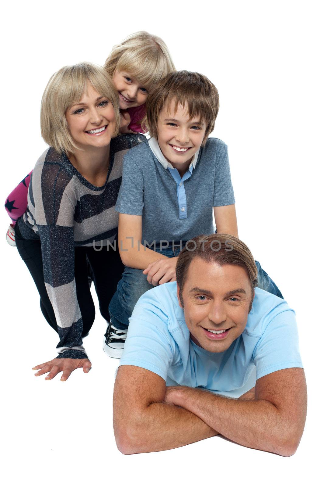 Fun loving family exhibiting great bonding by stockyimages