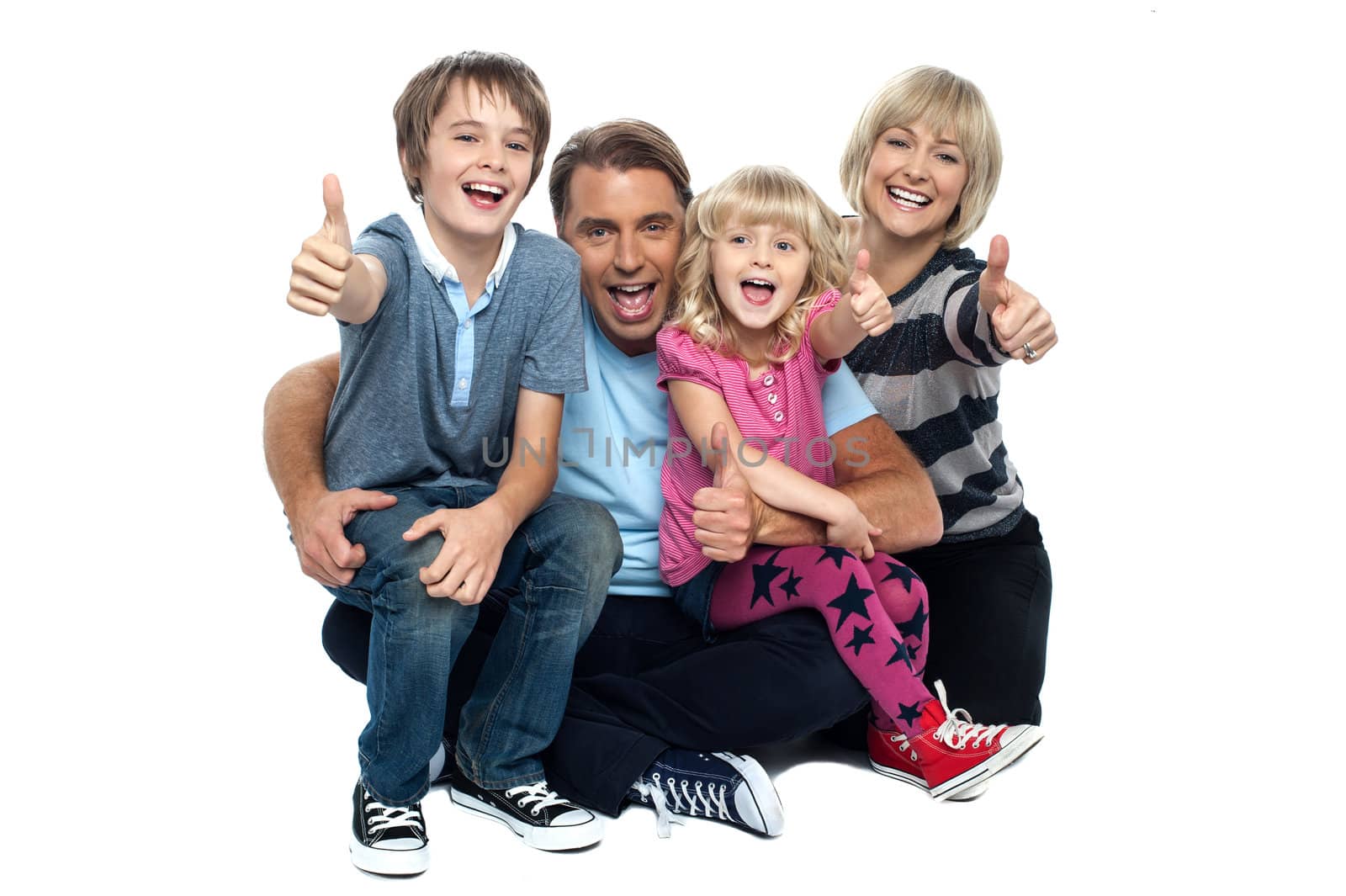 Cheerful thumbs up family by stockyimages