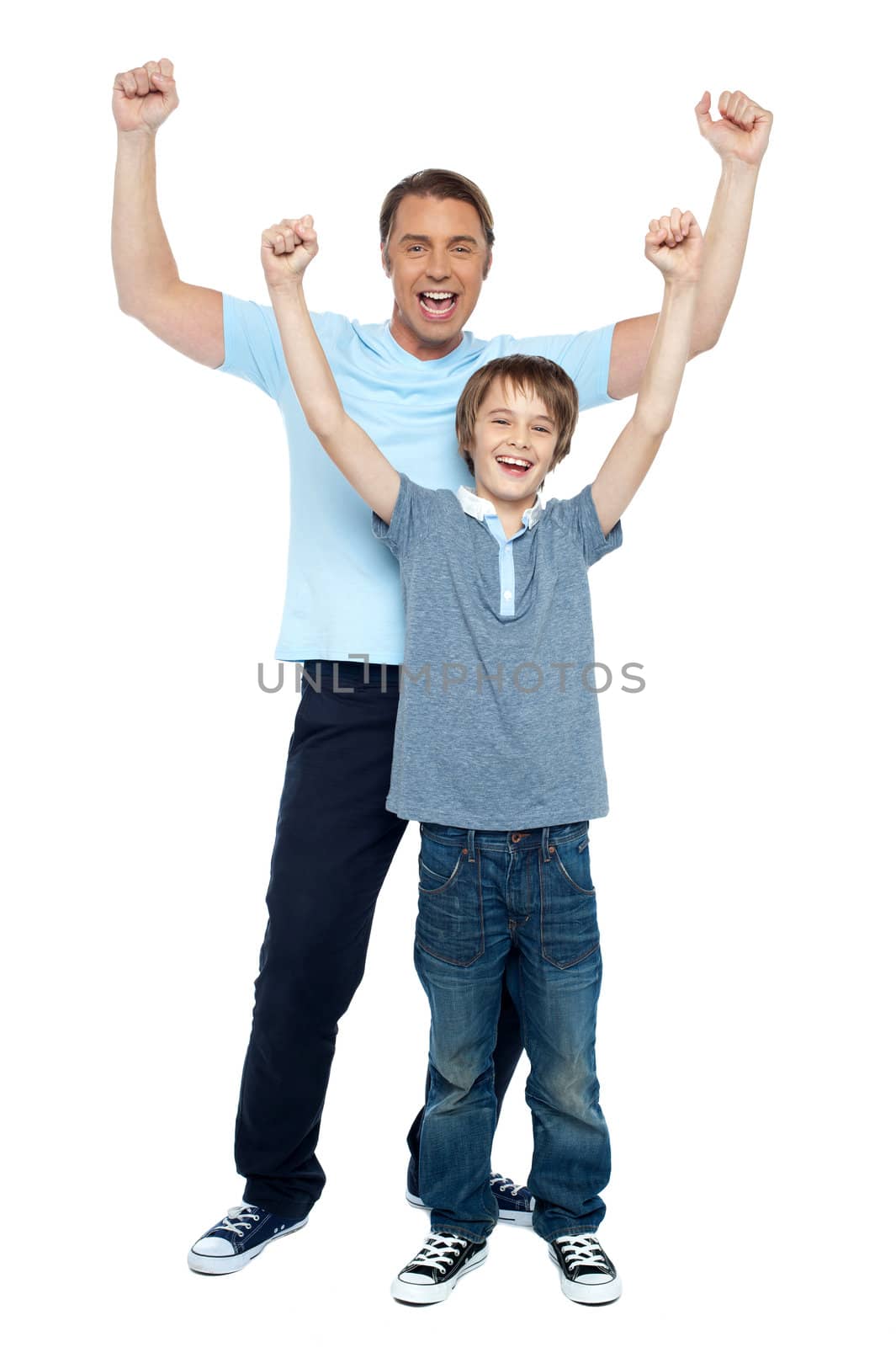 Father and son celebrating their success. Rejoicing with raised arms.