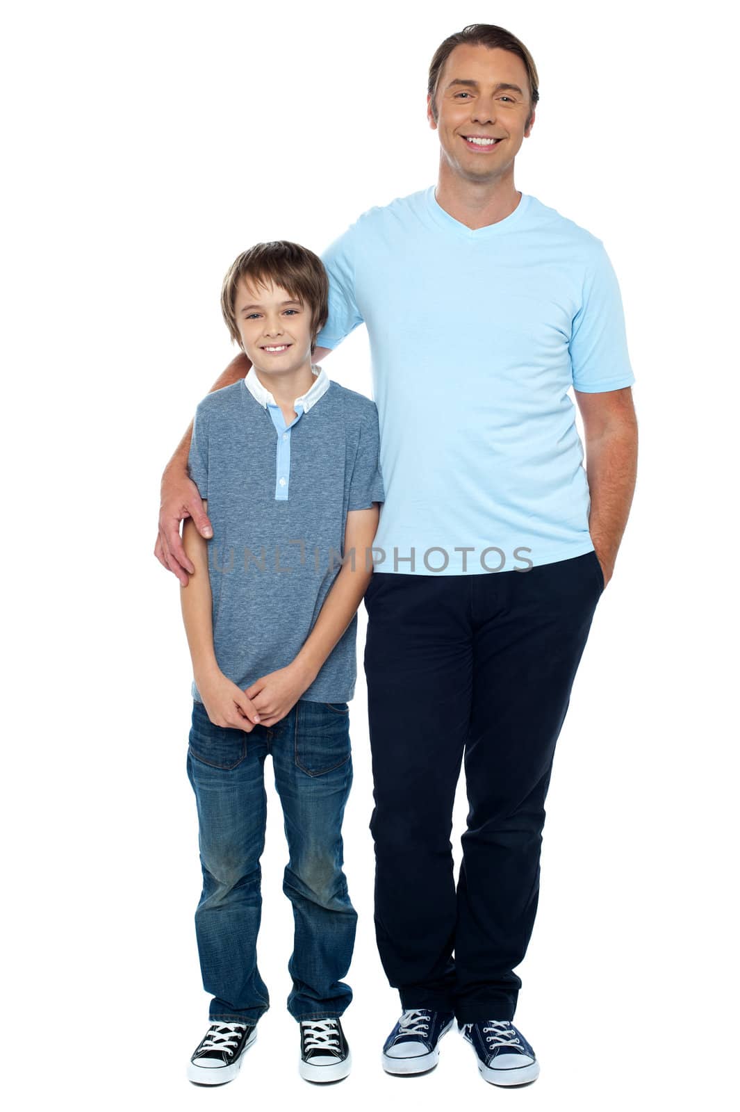 Casual studio shot of father and son. Full length portrait.