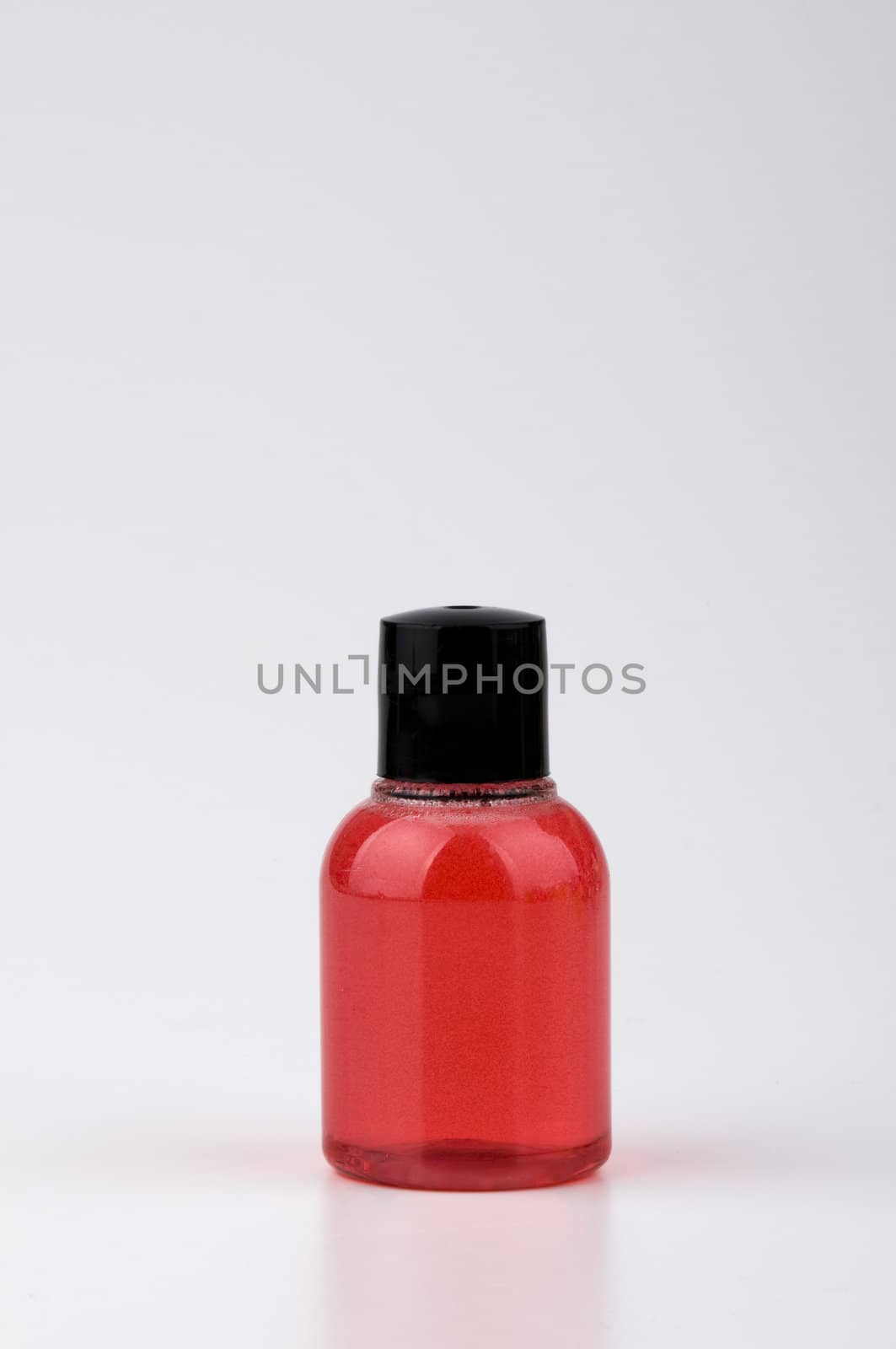 Red color bottle of shampoo