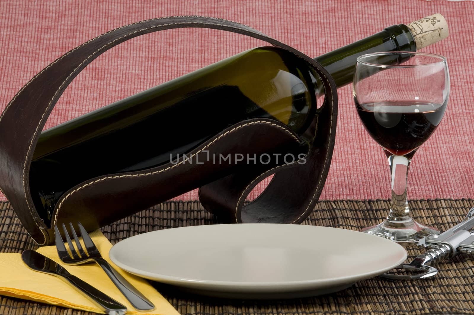 Bottle of wine, glass and plate