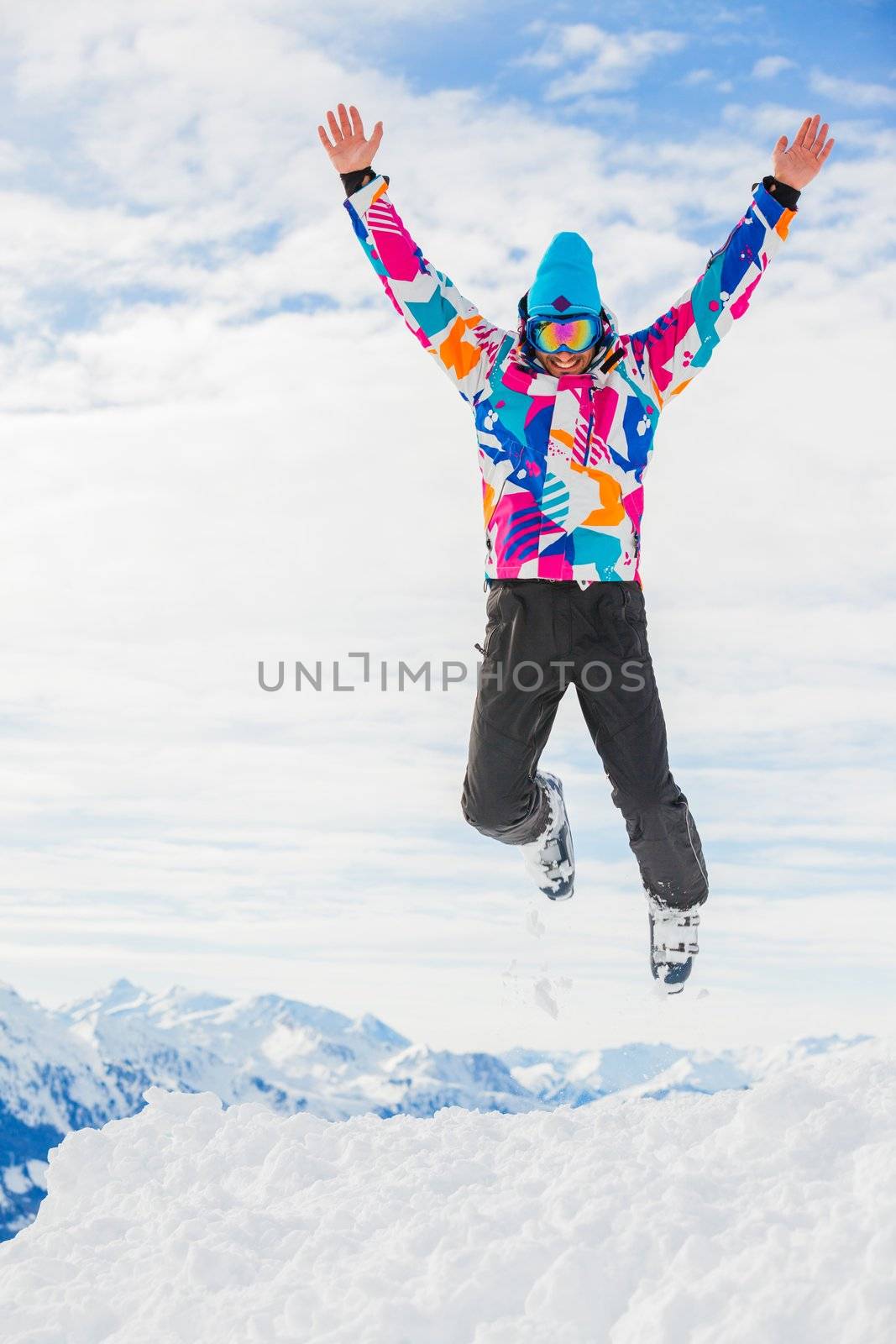 Young man a ski outfit jumping in snow at winter outdoor in the Zillertal Arena, Austria