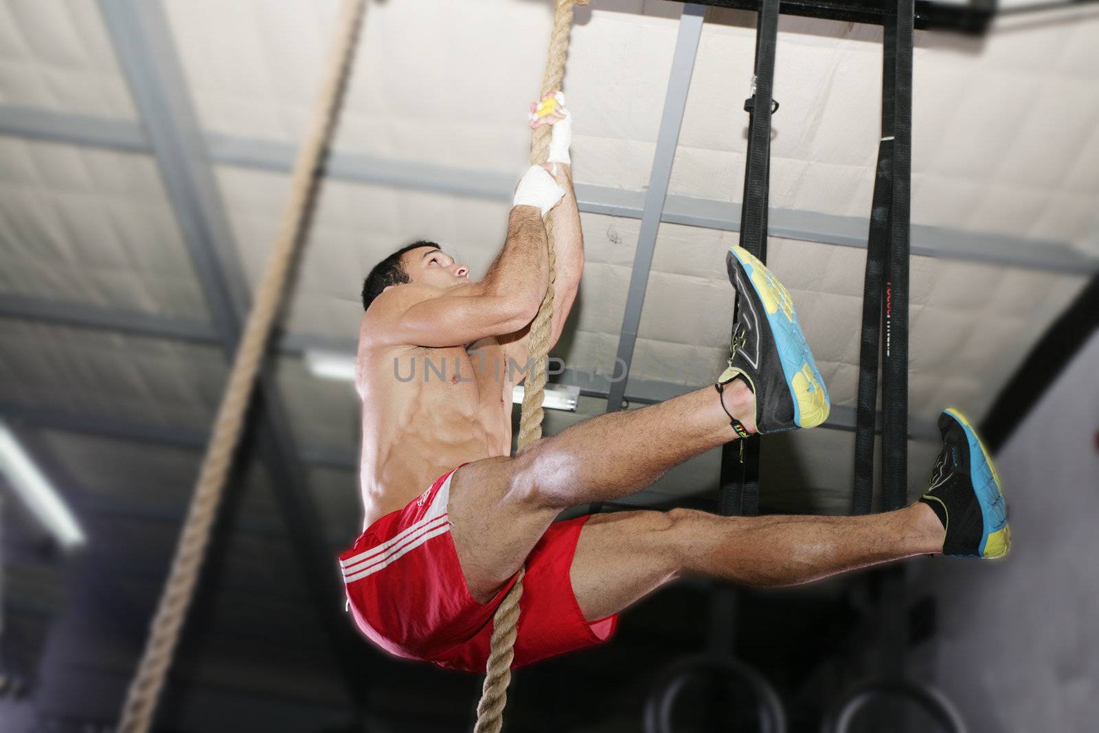 Crossfit rope climb exercise. Focus in the body