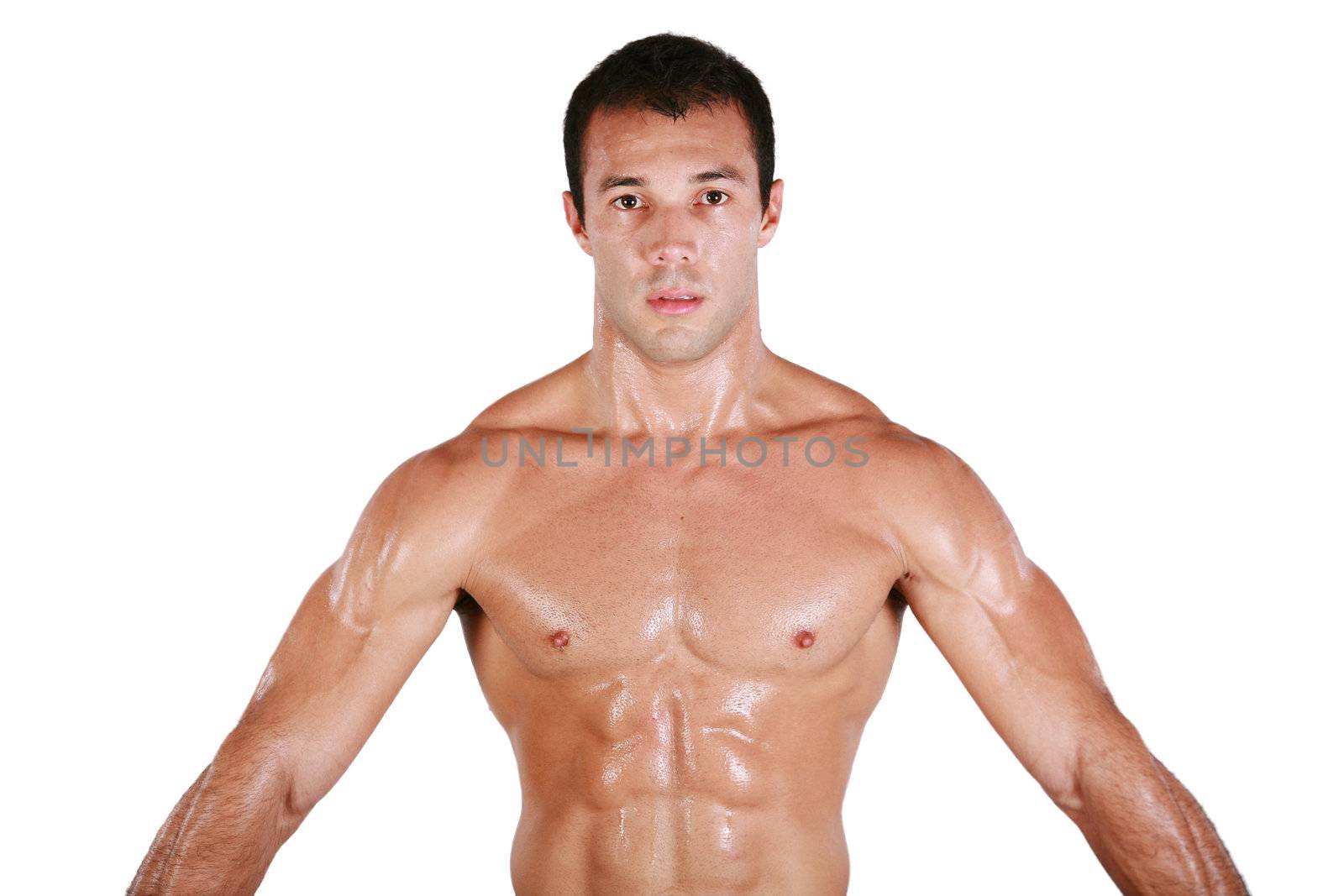 Muscular shirtless man after work out, looking at camera