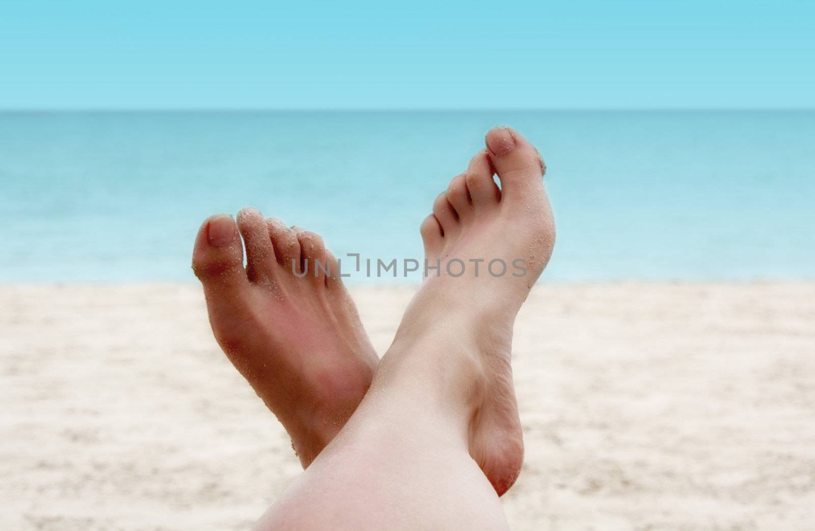 Sandy Woman Feet on a Tropical Beach