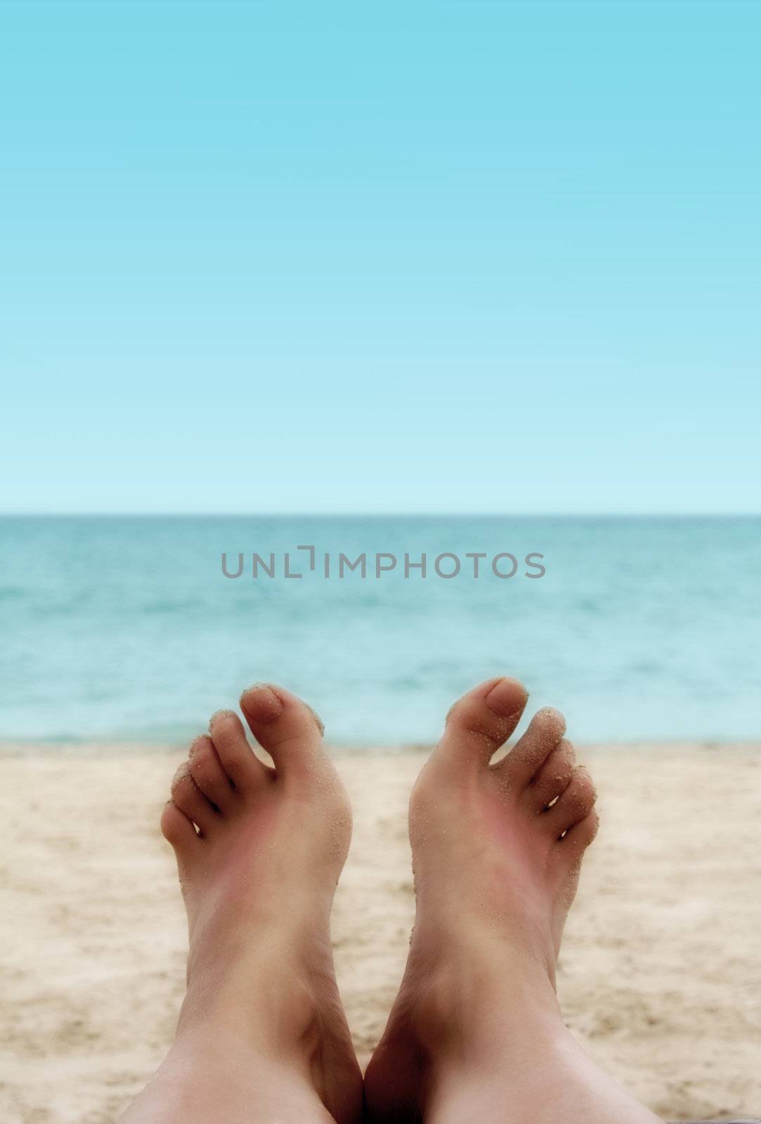 Sandy Woman Feet on a Tropical Beach