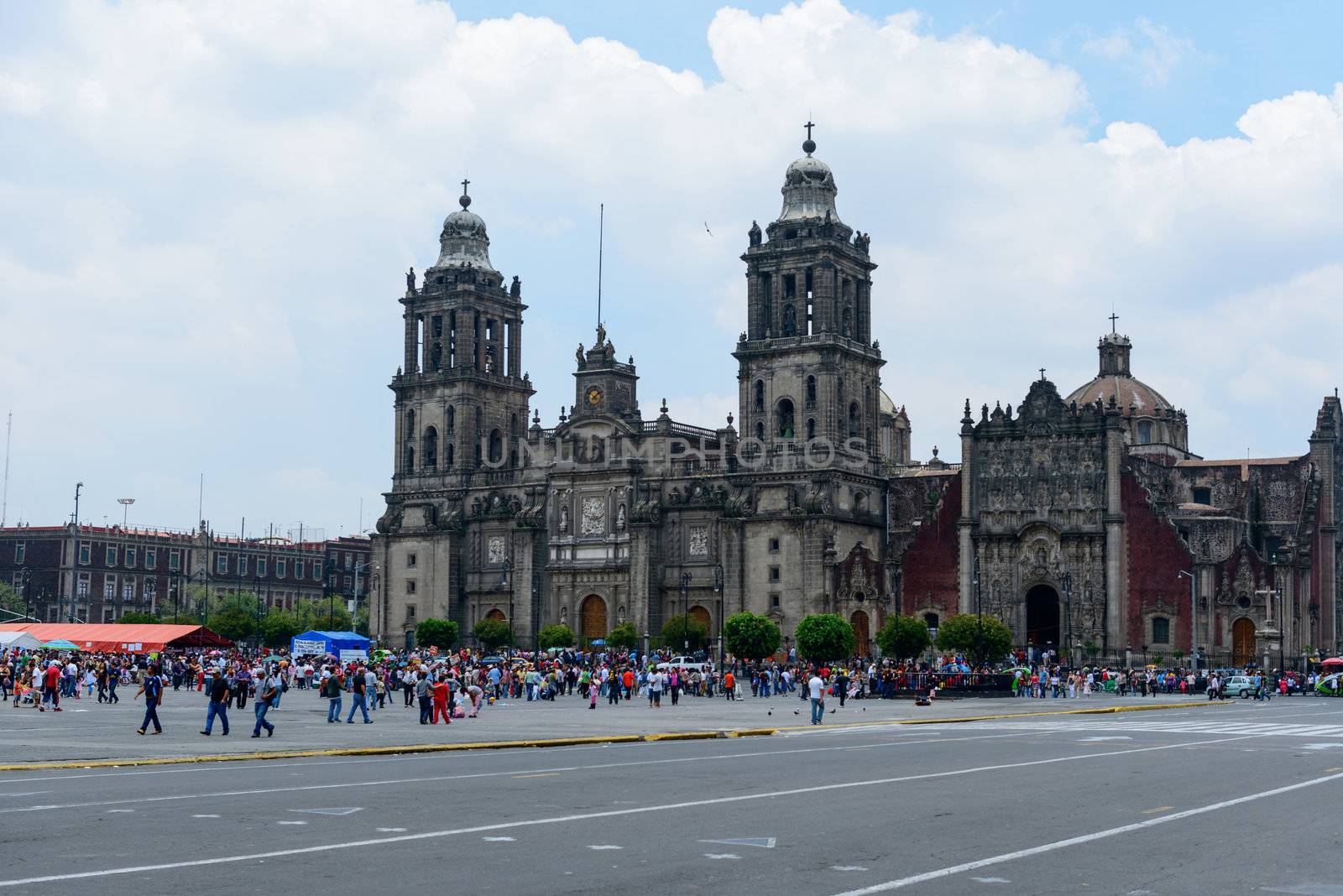 The Metropolitan Cathedral of the Assumption of Mary of Mexico City is the oldest and largest cathedral in the Americas and seat of the Roman Catholic Archdiocese of Mexico. It is situated atop the former Aztec sacred precinct near the Templo Mayor on the northern side of the Plaza de la Constitución in downtown Mexico City. The cathedral was built in sections from 1573 to 1813 around the original church that was constructed soon after the Spanish conquest of Tenochtitlán, eventually replacing it entirely. Spanish architect Claudio de Arciniega planned the construction, drawing inspiration from Gothic cathedrals in Spain.