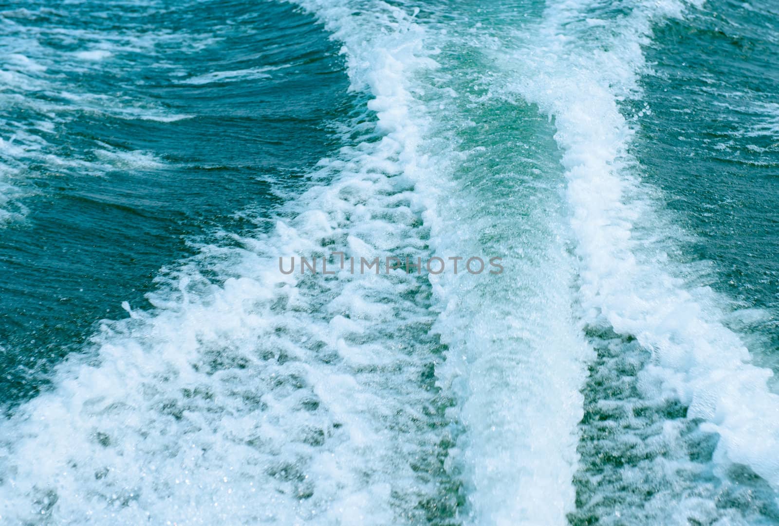 Water wave created behind high speed motorboat