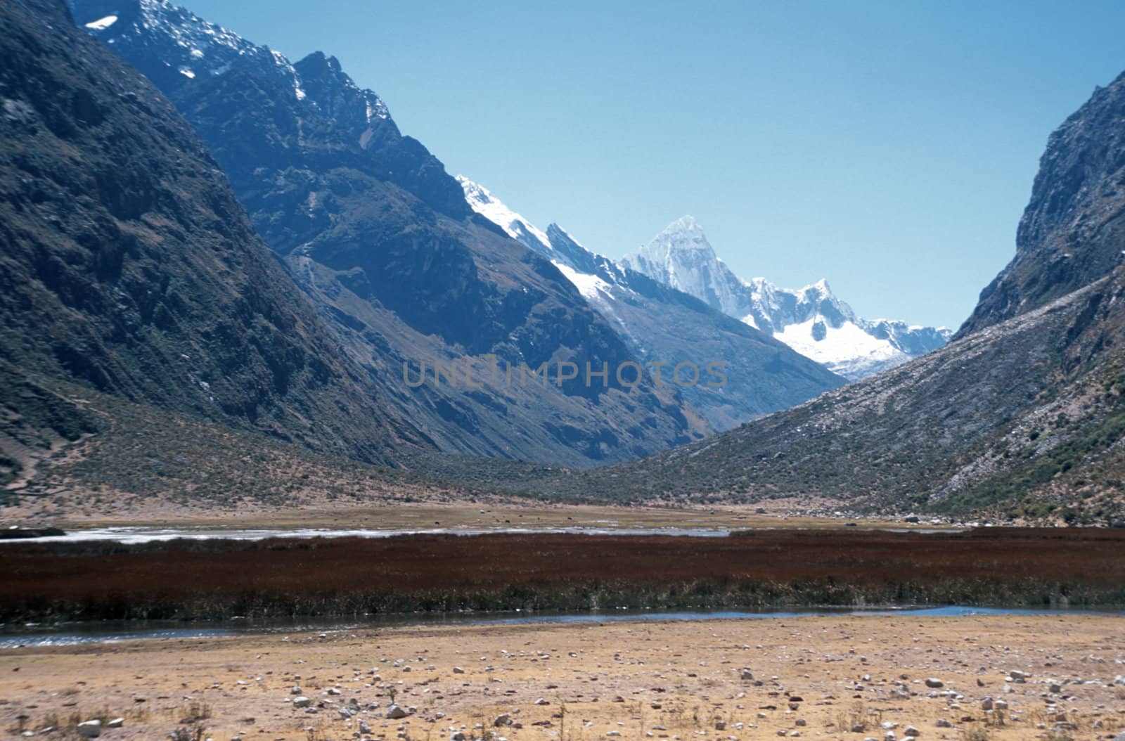 Huge snowy Andes Mountains in Peru viewed from a beautiful valley