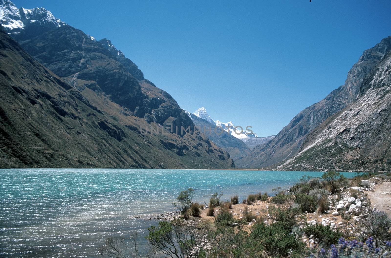 Stunning blue green lake deep within the Andes Mountains in Peru