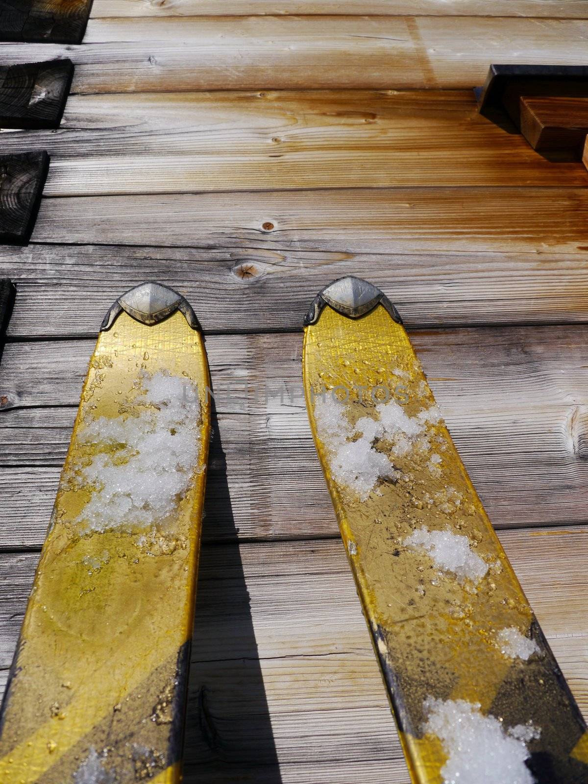 Image of skis leaning on a wooden wall