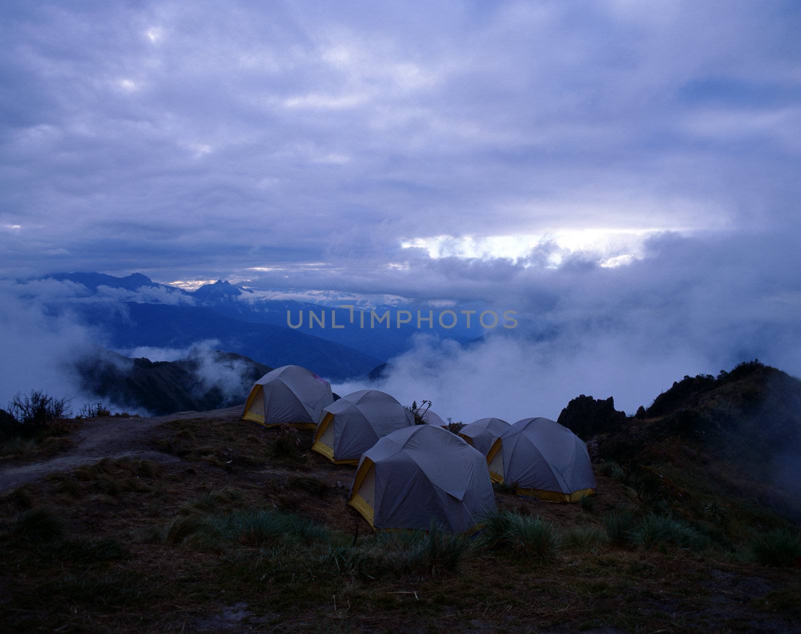 Overnight campsite of small tents on the mountainside, Peru.