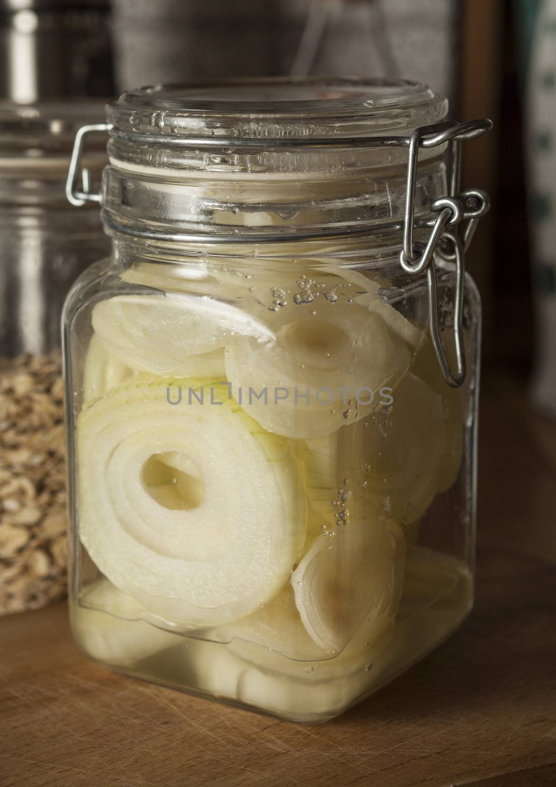 Jar with raw onion slices sprinkled with sugar giving onion syrup, traditional home remedy for cough and cold 