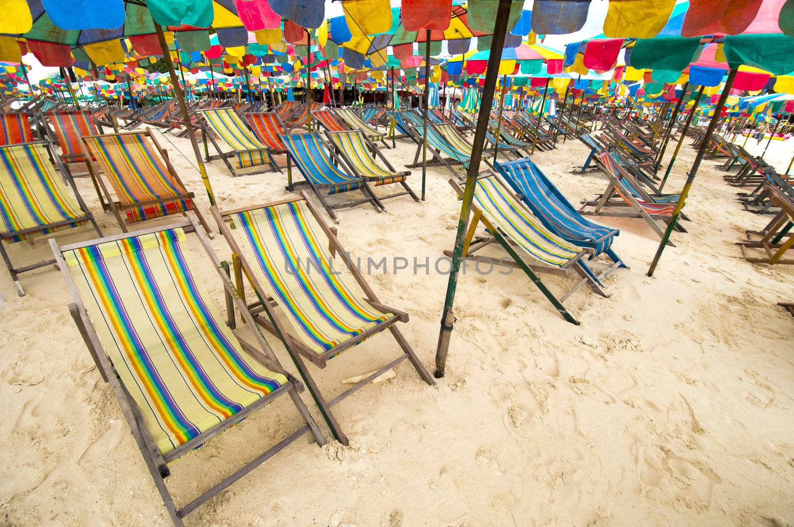 Beach chair and colorful umbrella on the beach , Phuket Thailand by TanawatPontchour