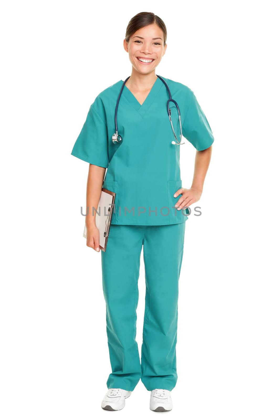 Nurse or young doctor standing smiling isolated on white background in full body. Woman medical professional in green scrubs smiling happy. Mixed race ethnic Chinese Asian and Caucasian female model.
