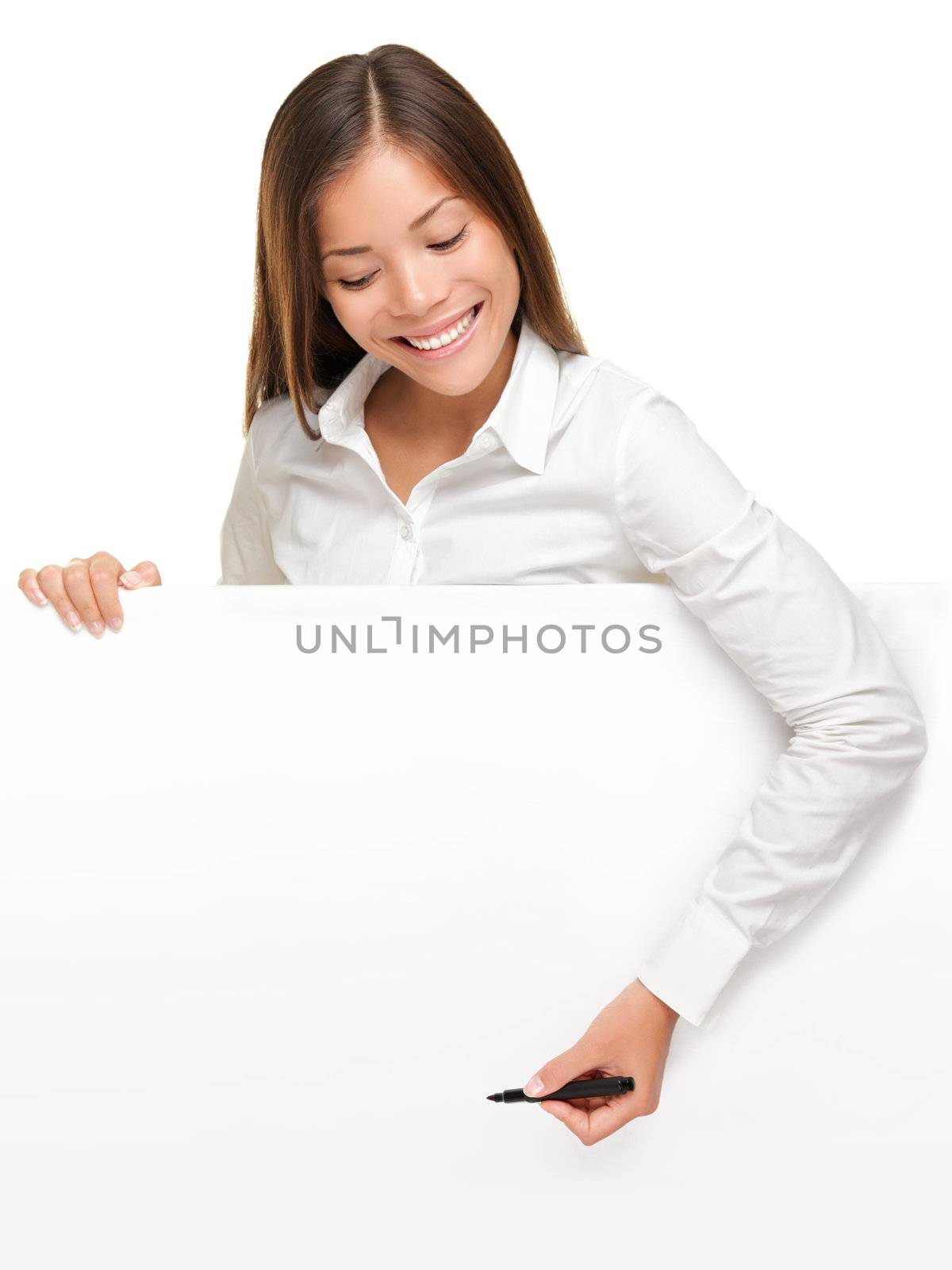 Woman writing on whiteboard sign from above. Woman holding pen smiling, drawing or writing with copy space for text. Beautiful mixed race Asian / Caucasian female businesswoman isolated on white background