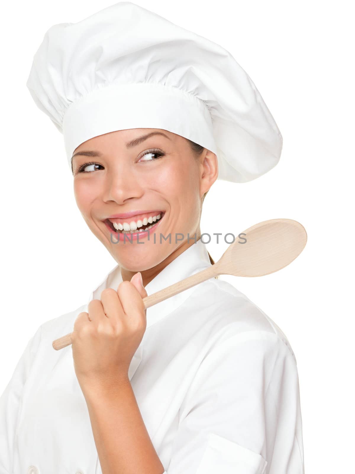 Chef woman smiling happy. Cook, chef or baker looking over should at copy space holding wooden spoon. Beautiful fresh Asian Caucasian female model isolated on white background.