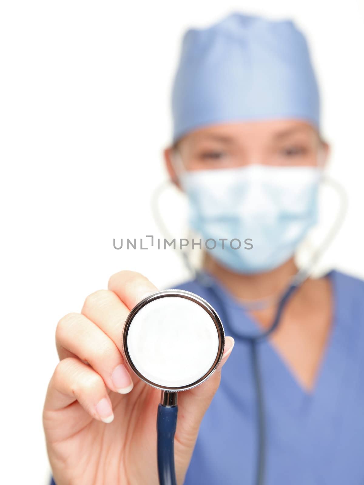 Medical doctor showing stethoscope close up isolated on white background. Female nurse or doctor wearing surgical mask and hat. Woman model.