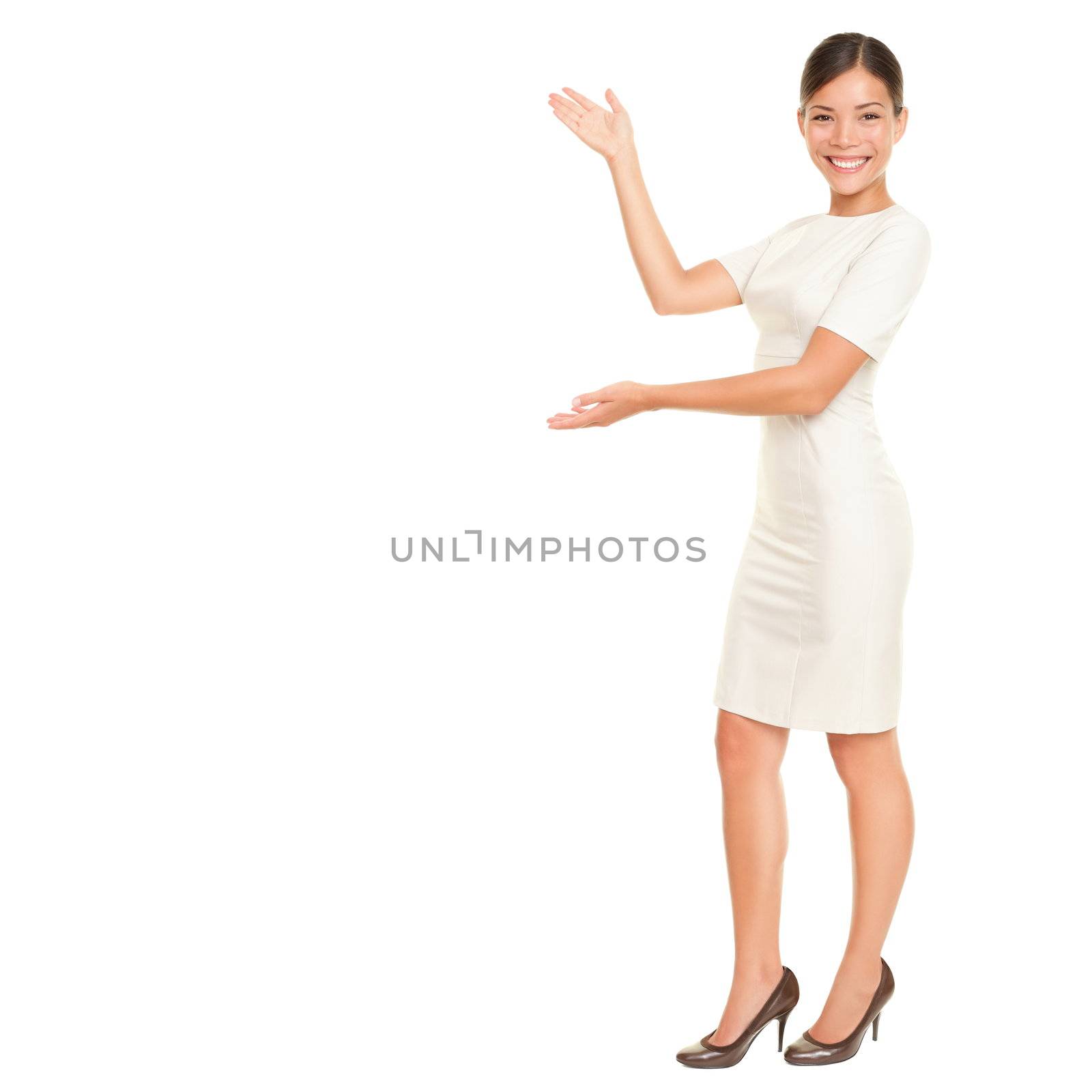 Full body woman showing and presenting copy space in business dress suit isolated on white background. Beautiful young mixed race chinese asian / white caucasian female businesswoman.