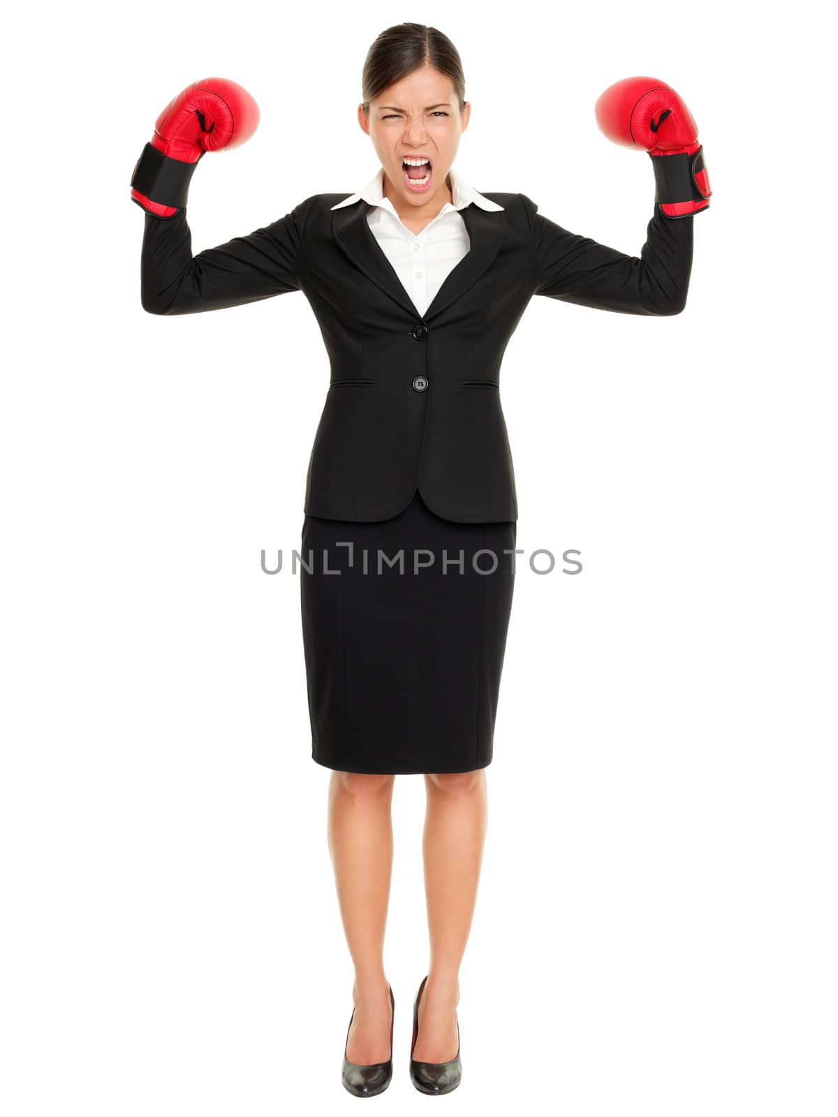Strong aggressive business winner woman concept. Businesswoman wearing boxing gloves showing flexing muscles standing in full length wearing suit. Caucasian Asian female model isolated on white background.