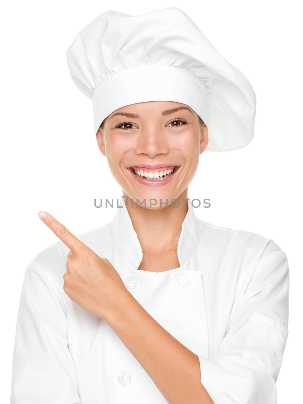 Woman chef pointing / showing empty blank copy space isolated on white background. Beautiful young mixed race Asian Caucasian female model smiling happy.