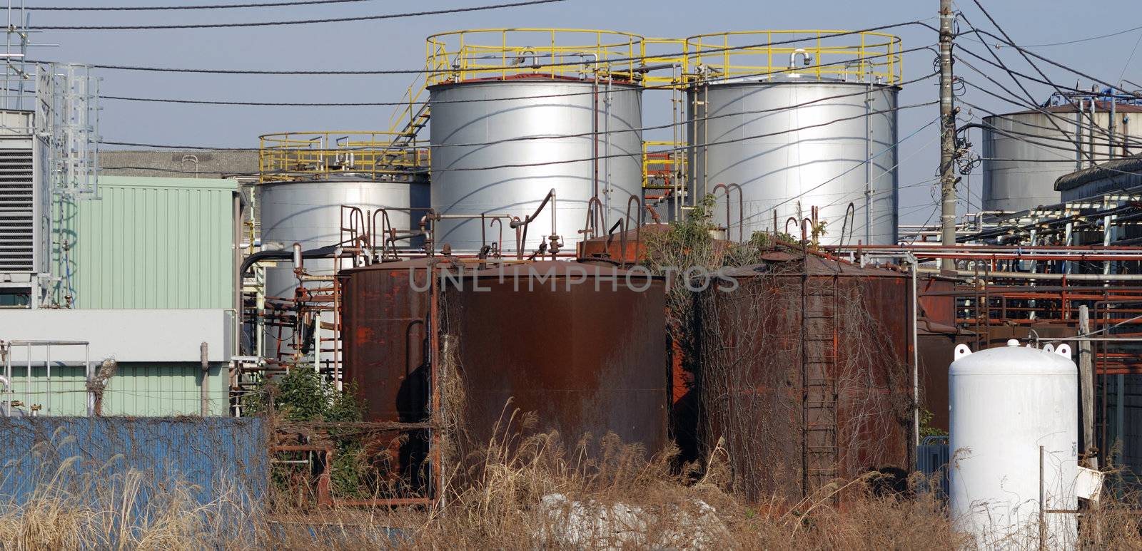 rusty pipes and huge barrels of old heavy industrial factory facilities