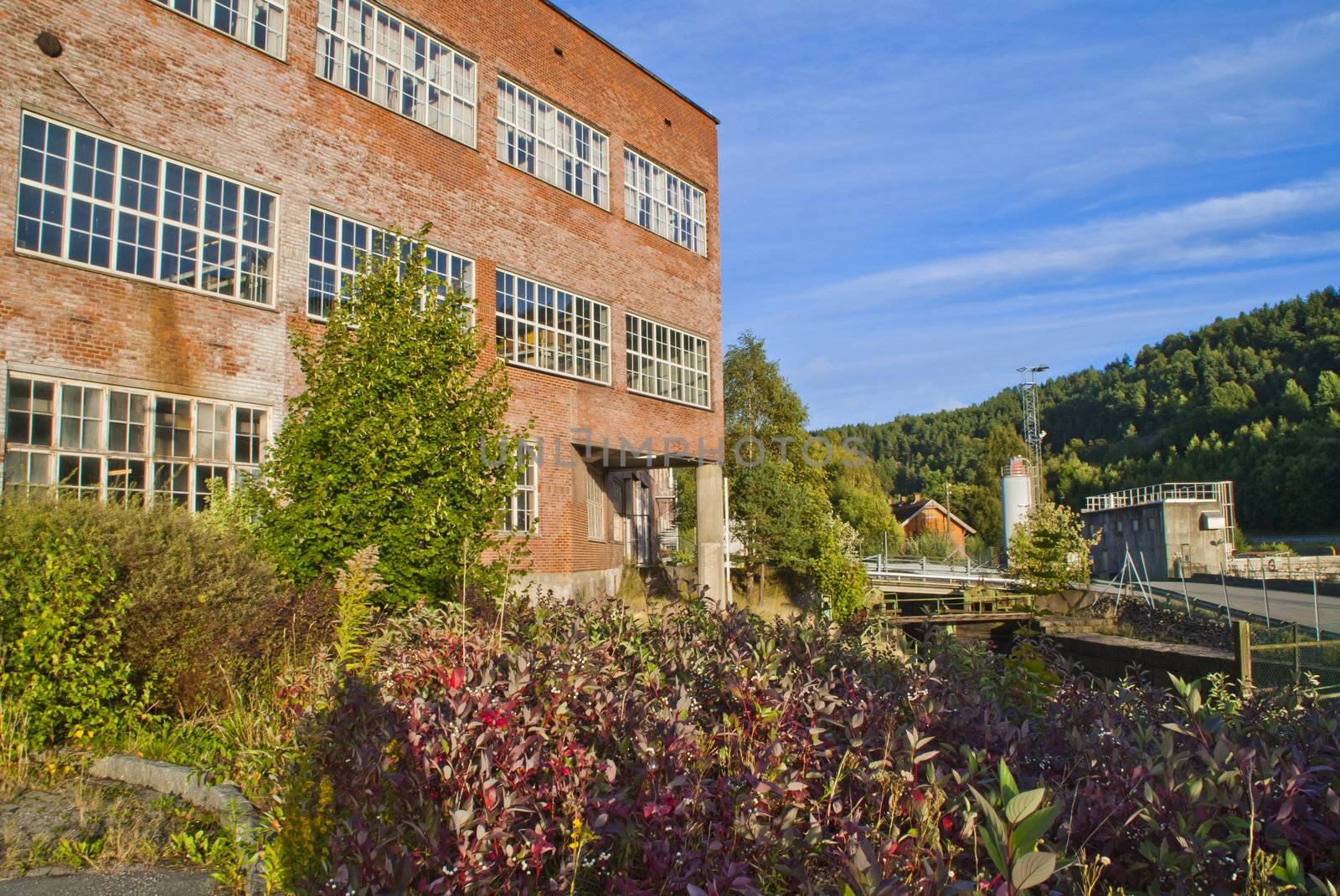 paper mill in Halden (Norway) which is the oldest wood processing plant in Norway, image is shot from the Tista river that flows past the factory. 