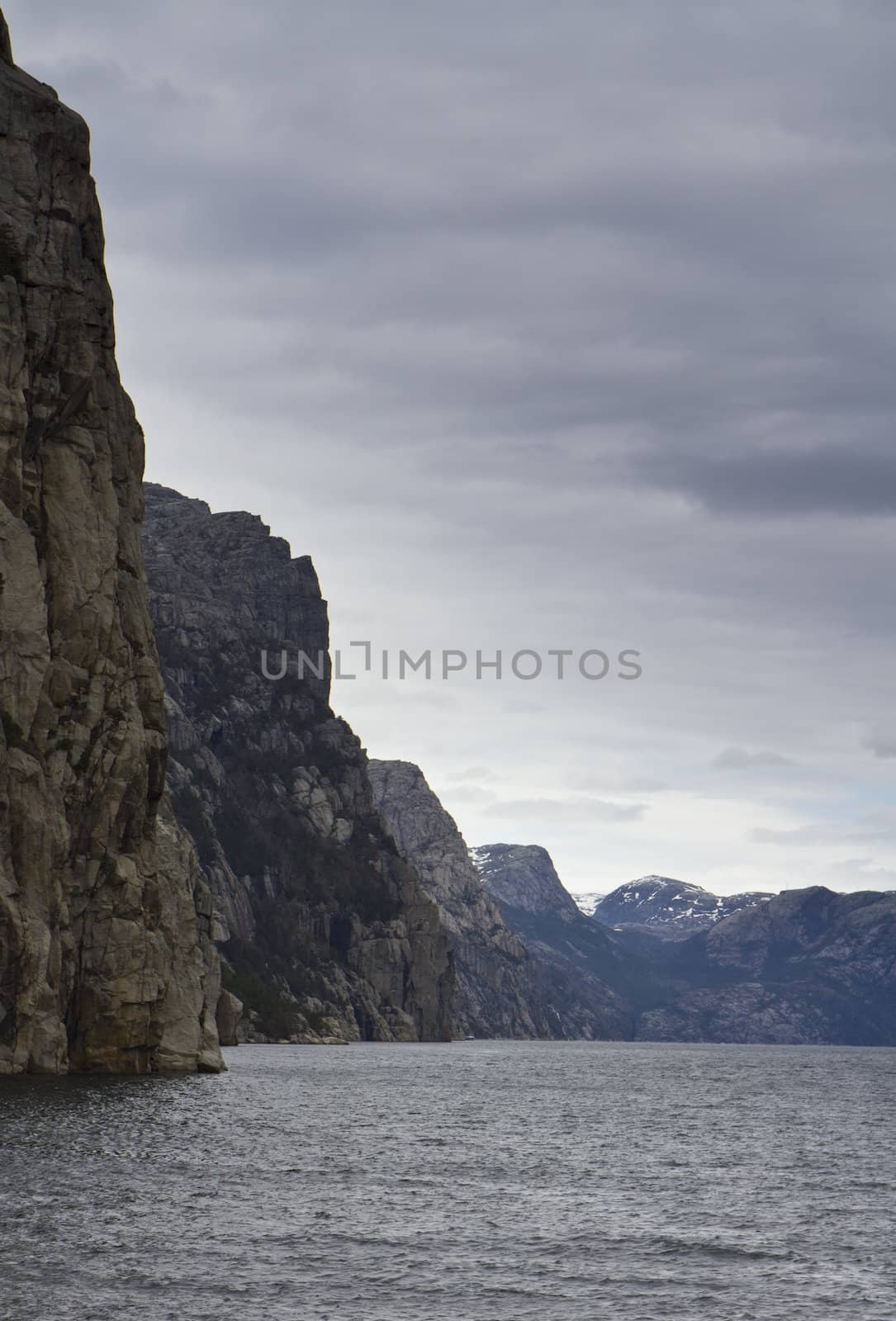 steep rock at coast in norway - vertical image