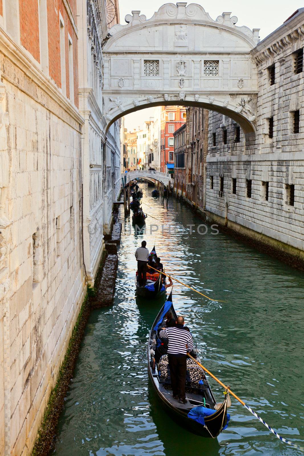 Romantic gondola cruise through the canals of Venice in evening light