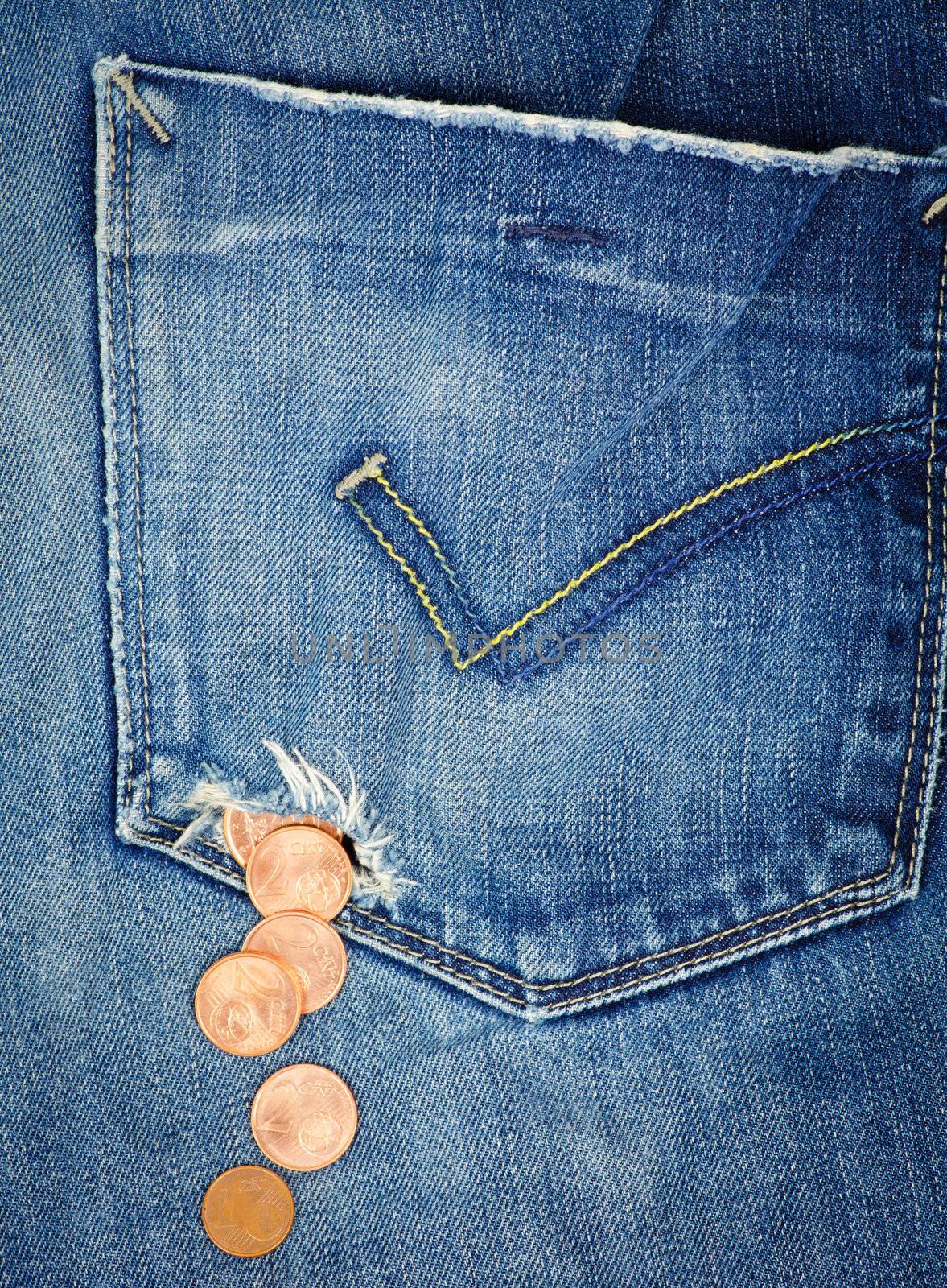 Money fall out from a hole in jeans pocket