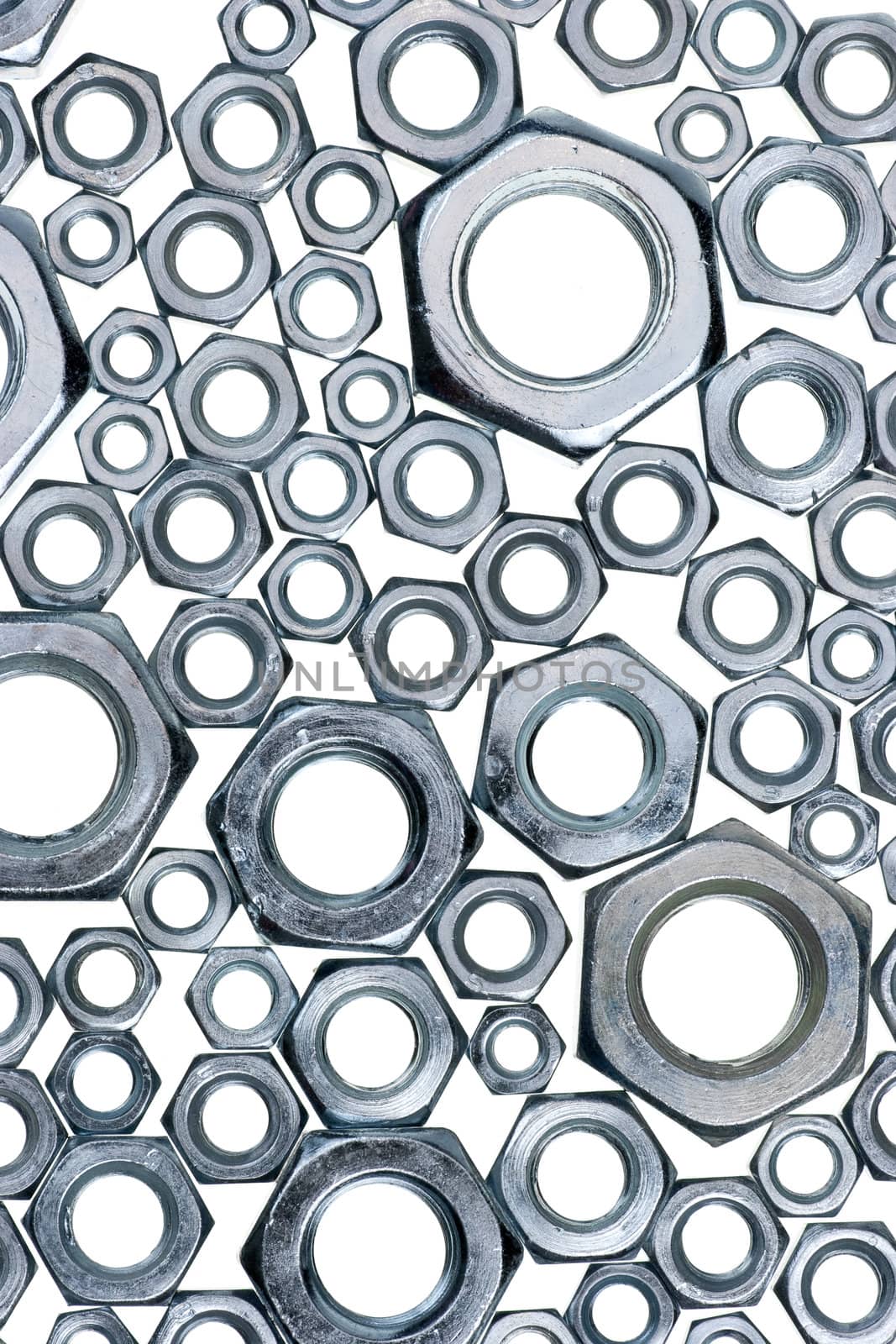 Assorted hex nuts on white background
